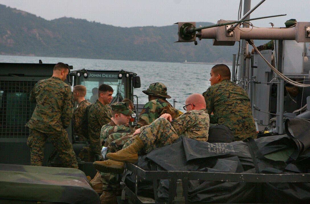 Marines with the 31st Marine Expeditionary Unit (MEU), and sailors with the Essex Amphibious Ready Group (ARG), wait aboard  a landing craft utility (LCU) as it approaches shore, Feb. 1. The MEU is currently in the offload phase in support of exercise Cobra Gold 2010 (CG’ 10). The exercise is the latest in a continuing series of exercises design to promote regional peace and security. (Official Marine Corps photo by Lance Cpl. Dengrier M. Baez)