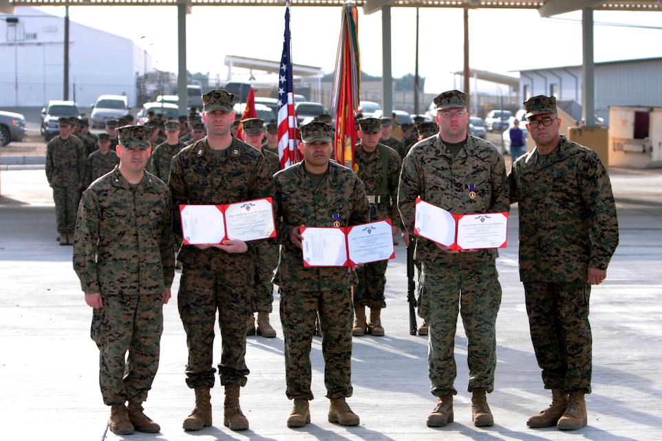 (from left to right) Lt. Col. Eduardo Abisellan, the commanding officer of 3rd Battalion, 11th Marine Regiment; Capt. Jarrod Overton, the commanding officer of Battery I; Staff Sgt. Lawrence Salcido, the battalion's local security chief; Sgt. Robert DeLuca, an ammunition technician; and Sgt. Maj. Robert Caldwell, the battalion sergeant major, pose for a photo during a promotions and awards ceremony Feb. 1. Overton, Salcido and DeLuca were all awarded Purple Heart Medals for wounds they received while on a mounted patrol during the battalion's deployment to Afghanistan last year.