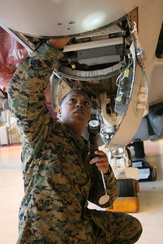 Staff Sgt. Luis A. Lorenzo, an airframes mechanic technician with Marine Attack Squadron 542, inspects the underside of an AV-8B Harrier in the squadron’s hangar. Lorenzo said he and other Marines with his military occupational specialty conduct the final inspection before an aircraft is cleared to fly a mission.