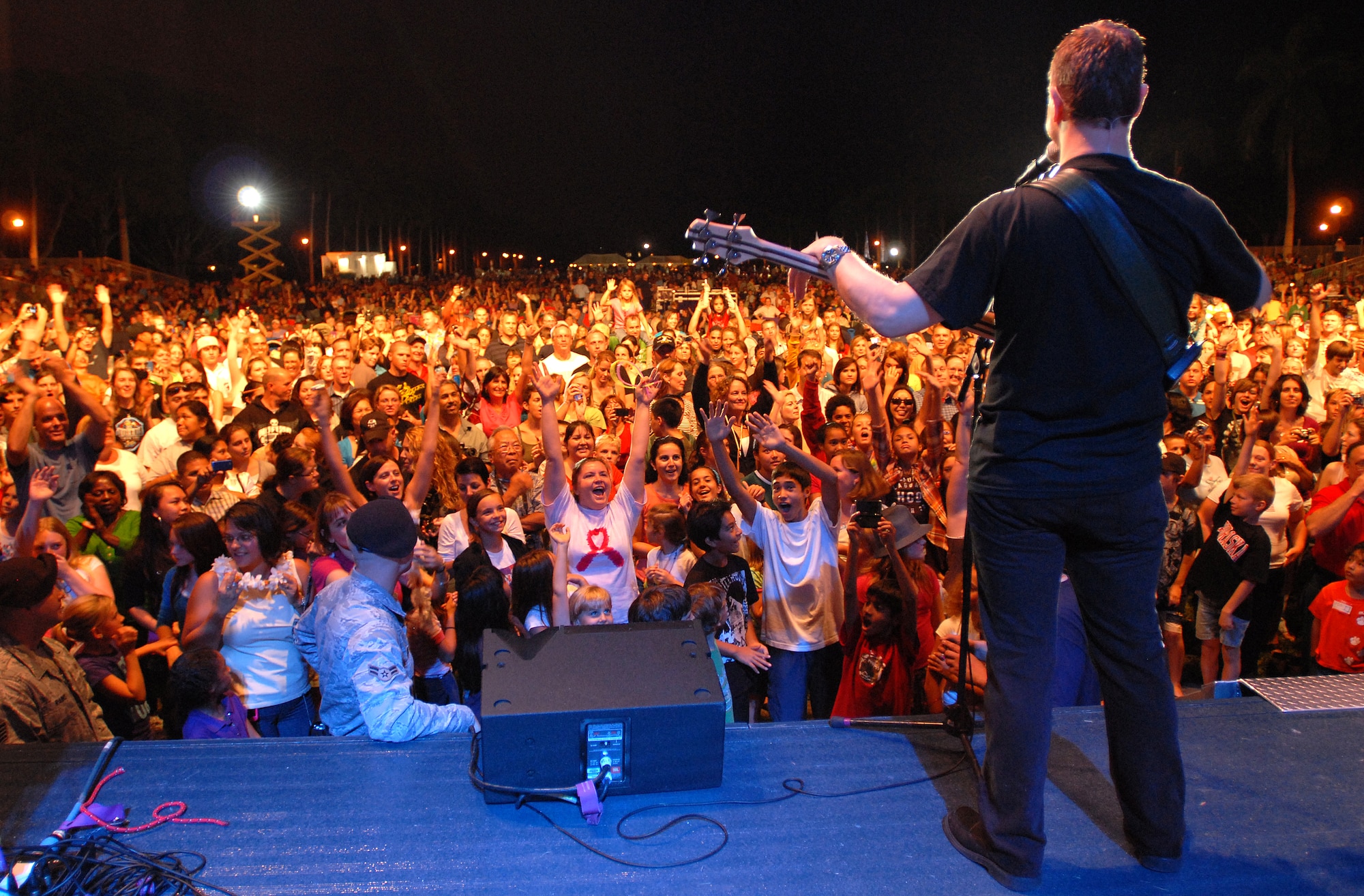 HICKAM AIR FORCE BASE, Hawaii -- Gary Sinise, bass guitarist for the Lt. Dan Band, performs for more than 6,000 Hickam and Pearl Harbor service members at Freedom Tower Jan. 30. The Lt. Dan Band covers everything from Springsteen to Linkin Park, from Aretha Franklin to Jimi Hendrix.  The concert is sponsored by USO and Triwest. The band is known for a character Sinise portrayed in the 1994 Academy Award winning film, Forrest Gump. Sinise received an Oscar nominated for Best Supporting Actor. (U.S. Air Force photo/Staff Sgt. Mike Meares)