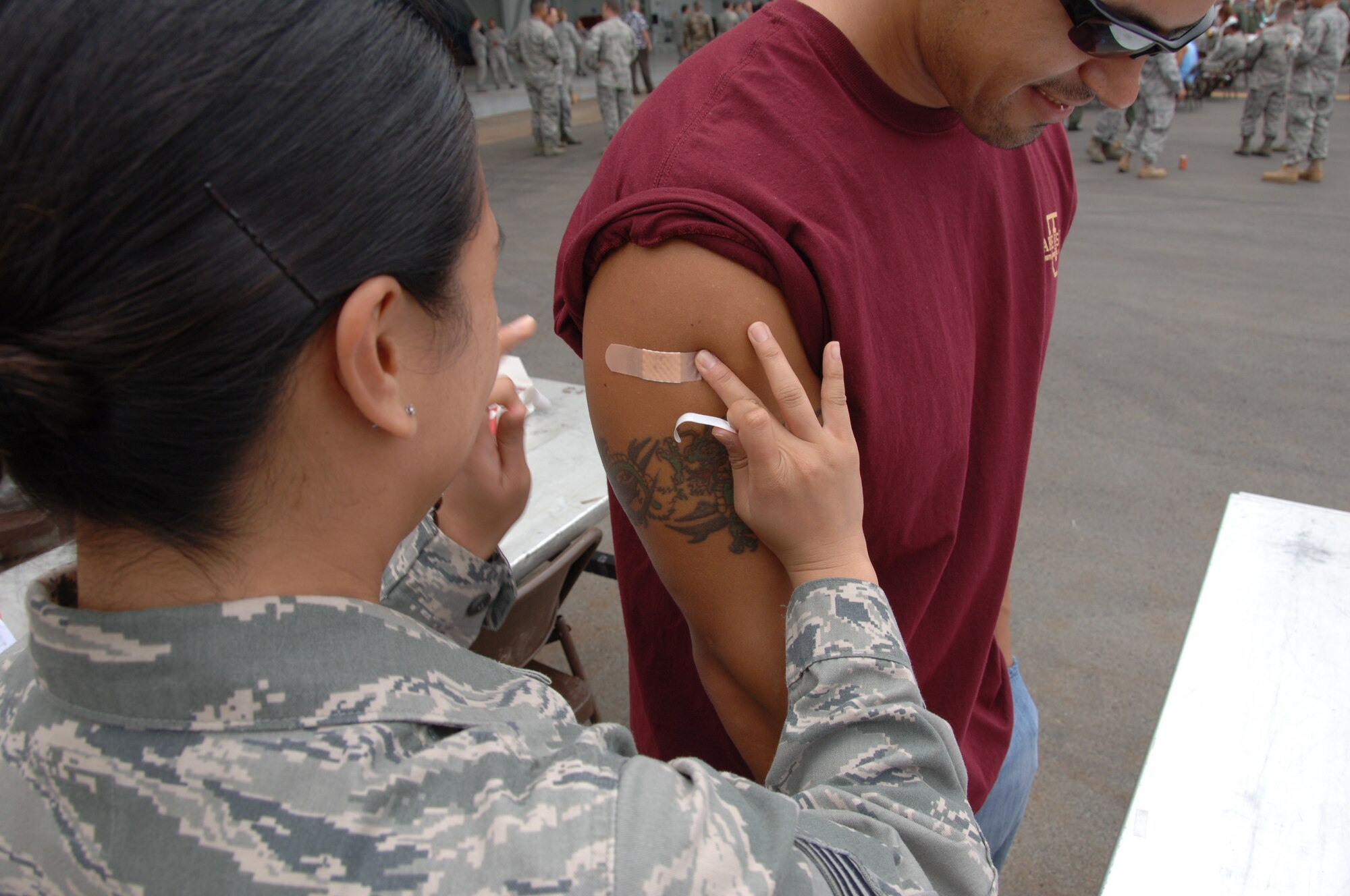 HICKAM AIR FORCE BASE, Hawaii - Airmen receive H1N1 vaccinations after a commander's call during Wingman's Day here, Jan. 29. After the commander’s call, a burger burn followed as airmen were treated to burgers and hot dogs, all support of Wingman Day. (U.S. Air Force photo by Senior Airman Nathaniel Allen)	