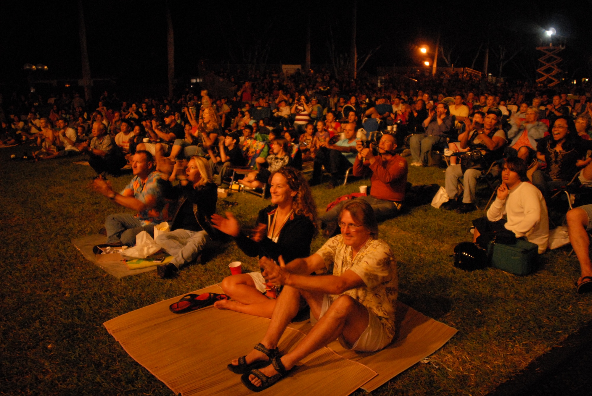 HICKAM AIR FORCE BASE, Hawaii - A crowd of Air Force members and spouses watch the beginning of the Lt. Dan Band concert here, Jan 30. The Lt. Dan Band played songs from Bruce Springsteen, Linkin Park, to Aretha Franklin and Jimmy Hendrix. The Lt. Dan Band performs 30-40 shows per year, most of which are in support of the USO and other charities or benefits. (U.S. Air Force photo by Senior Airman Gustavo Gonzalez)