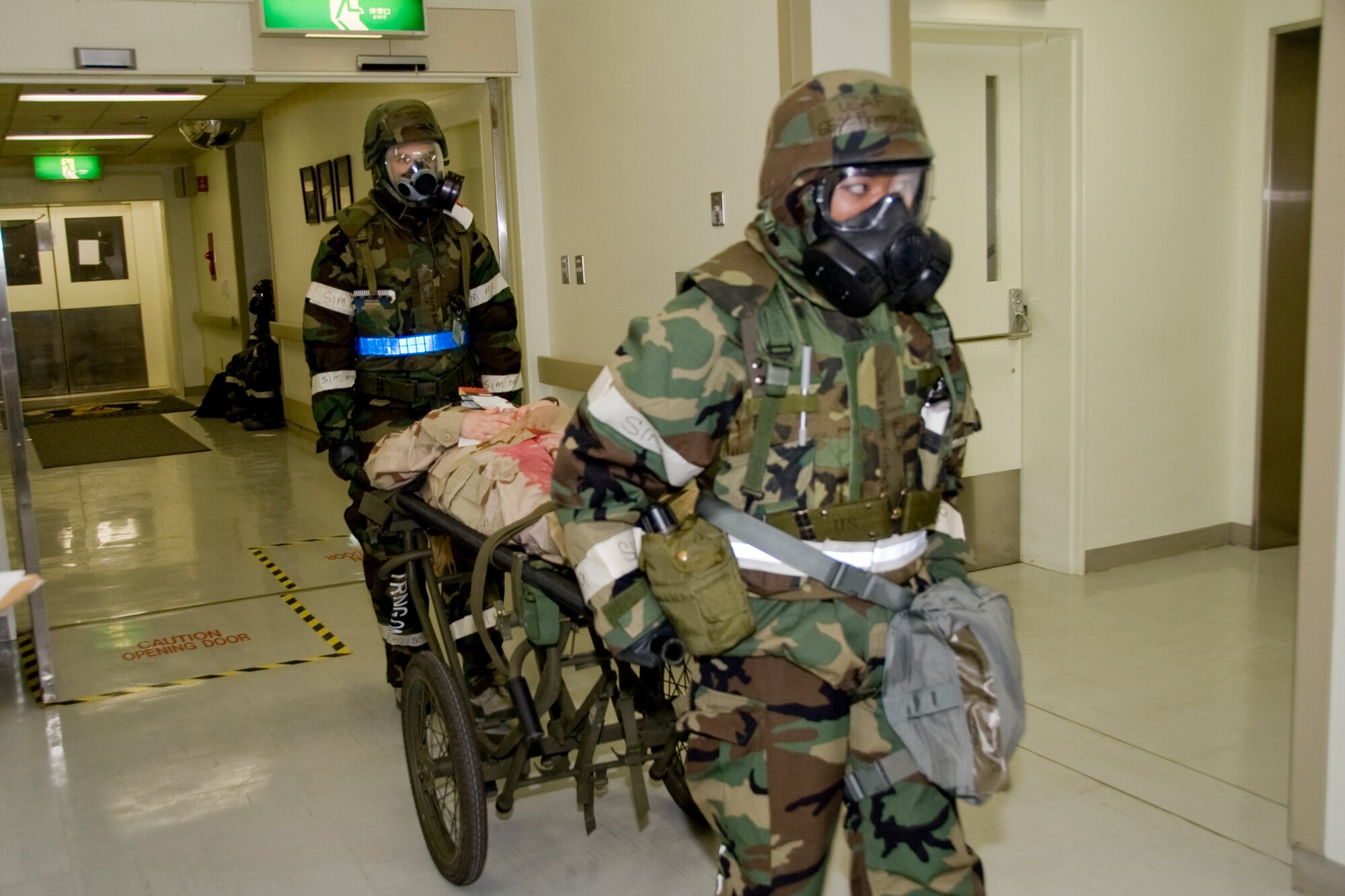 MISAWA AIR BASE, Japan -- Two Airmen from the 35th Medical Group transport a simulated patient with an abdominal wound at the medical treatment facility during Exercise Beverly Sunrise 10-01 Feb. 1. The exercise tested the medical group staff's ability to respond to a mass casualty scenario. (U.S. Air Force photo/Staff Sgt. Rachel Martinez)