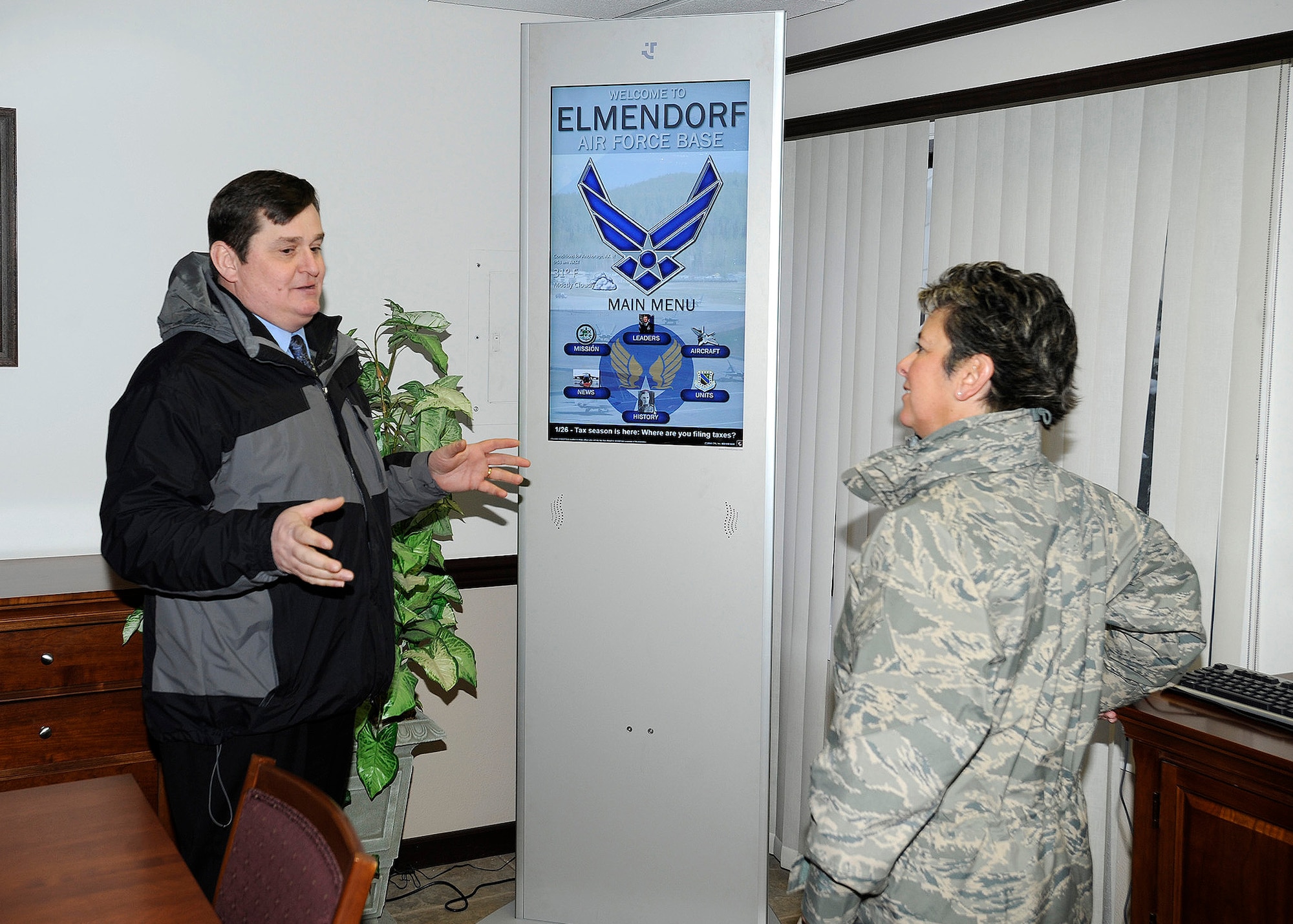 ELMENDORF AIR FORCE BASE, Alaska -- Mr. Stephen Lee, 3rd Wing Public Affairs,  shows  Maj. Gen. Anita Gallentine the new kiosk in the distinguished visitors lounge during the  Installation Excellence team’s  tour of the passenger terminal  Jan. 28. Maj. Gen. Gallentine and the Installation Excellence team were here to evaluate Elmendorf as one of two finalists for the Air Force Installation of the Year award. (Air Force photo by Senior Airman Matt Coleman-Foster)