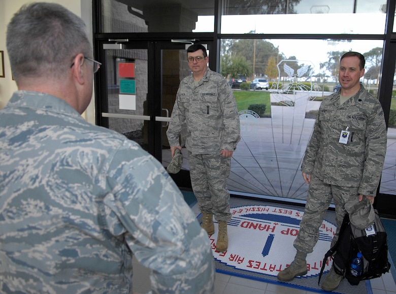 VANDENBERG AIR FORCE BASE, Calif. --  Col. Carl DeKemper, the 576th Flight Test Squadron commander, greets and welcomes Col. Lyman Faith, the lead inspector from the 20th Air Force inspection team, and Lt. Col. Andrew Healy, the lead inspector from the Air Force Global Strike Command inspection team, at the front doors of the 576th FLTS building here Monday, Feb. 1, 2010. The 576th FLTS is undergoing a 20th AF technical evaluation and an Air Force Global Strike Command logistics compliance assessment program. (U.S. Air Force photo/Airman 1st Class Andrew Lee) 