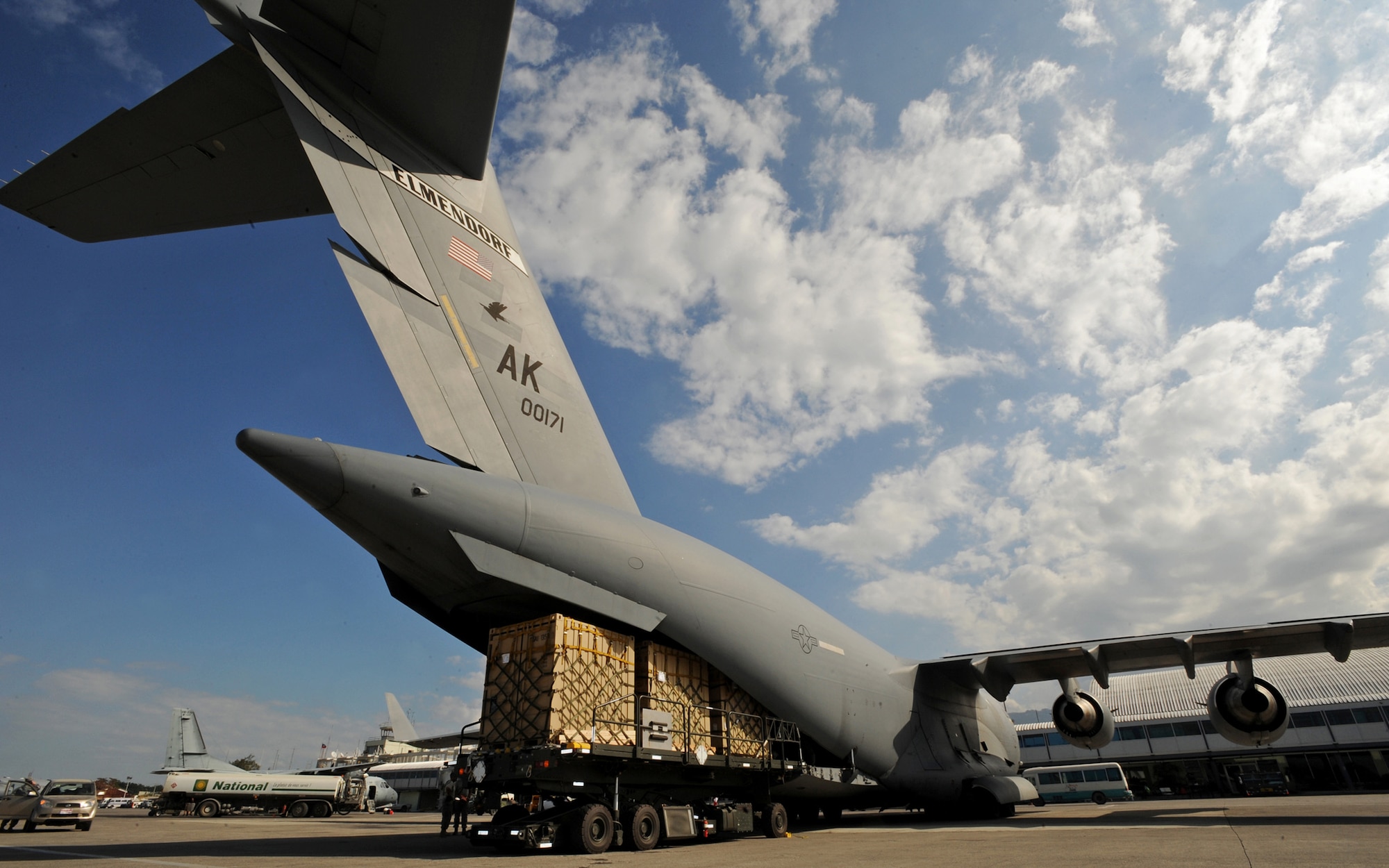PORT-AU-PRINCE, Haiti -- Cargo Pallets are removed from a 517th Airlift Squadron C-17 Globemaster III at the Port-Au-Prince International Airport Jan. 31. The C-17 delivered Soldiers, a truck with water tank, and pallets of gear to be used in the Haiti relief effort. (U.S. Air Force photo/Senior Airman Laura Turner)