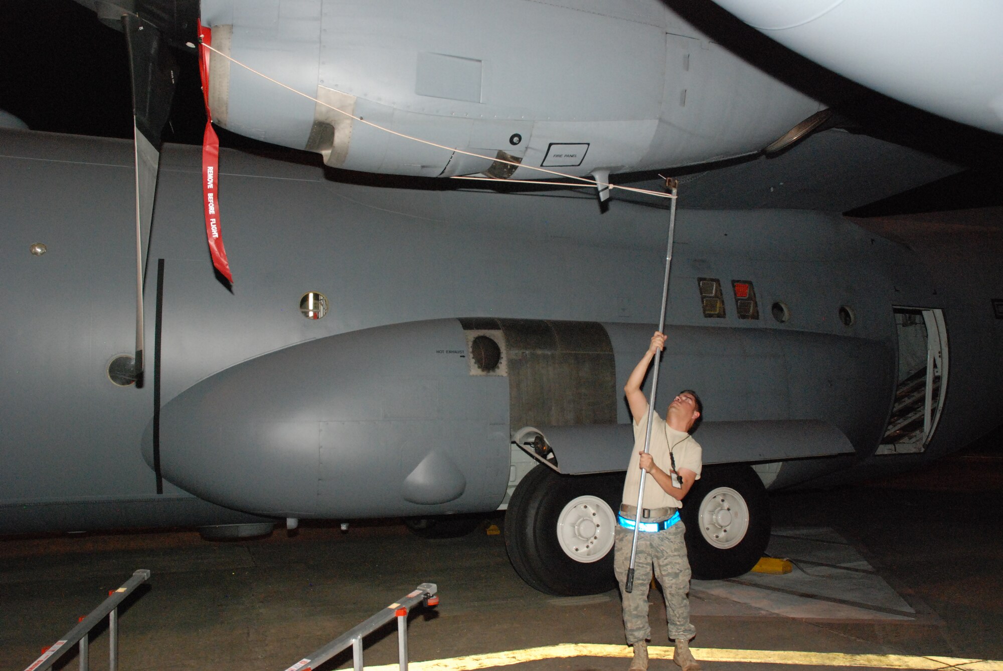 Tech. Sgt. Steve Cisneros, 35th Expeditionary Airlift Squadron crew chief,  assigned from the 302nd Airlift Wing, Peterson AFB, Colo.,  inserts a protective plug for a Coronet Oak C-130 engine air intake chamber.  (U.S. Air Force photo/Master Sgt. Stan Coleman

