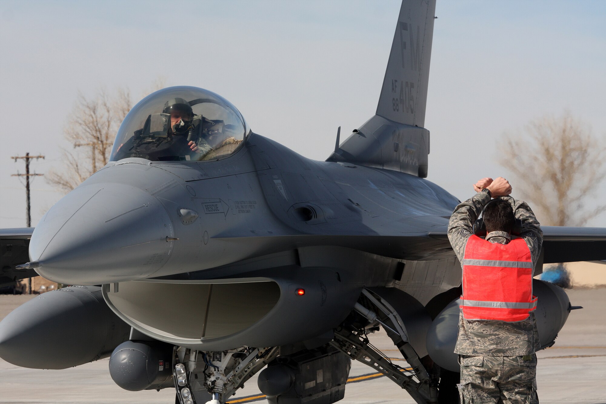 A crew chief from the 482nd Maintenance Group of Homestead Air Reserve Base, Fla., taxis an F-16 aircraft for a pre-flight inspection during Red Flag. This is the first time in 16 years Homestead ARB has participated in Red Flag. (U.S. Air Force photo/ Tech. Sgt. Bucky Parrish)
