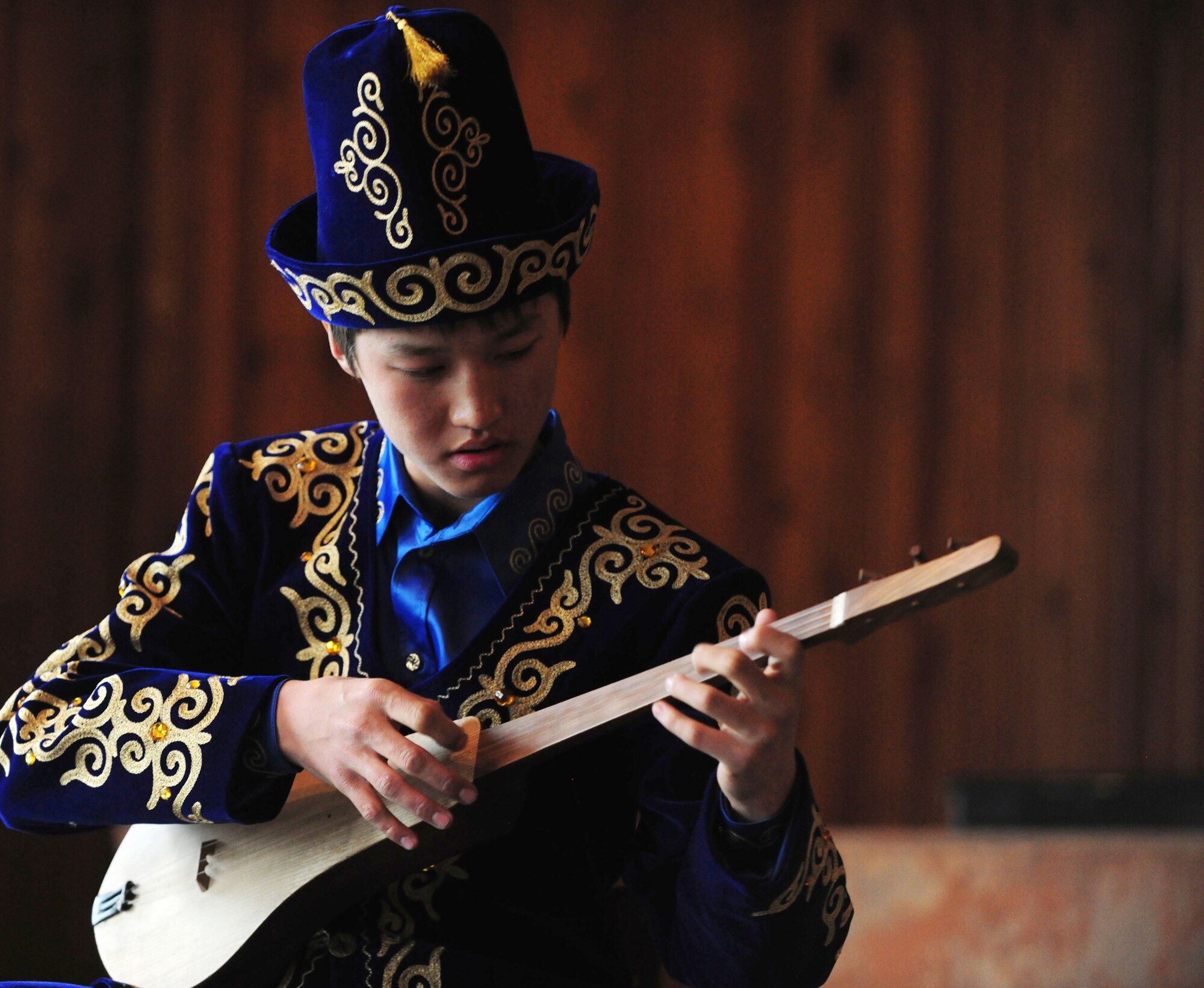 Kyrgyz students play the Komuz, a local traditional instrument, for the Washington Redskins Cheerleaders Jan. 27, 2010, at the Abdraev Musical Boarding School in Bishkek, Kyrgyzstan. The Transit Center at Manas in Kyrgyzstan is their first stop in a two-week long tour where they will perform for Airmen, Soldiers, Sailors and Marines deployed overseas. (U.S. Air Force photo/Senior Airman Nichelle Anderson)

