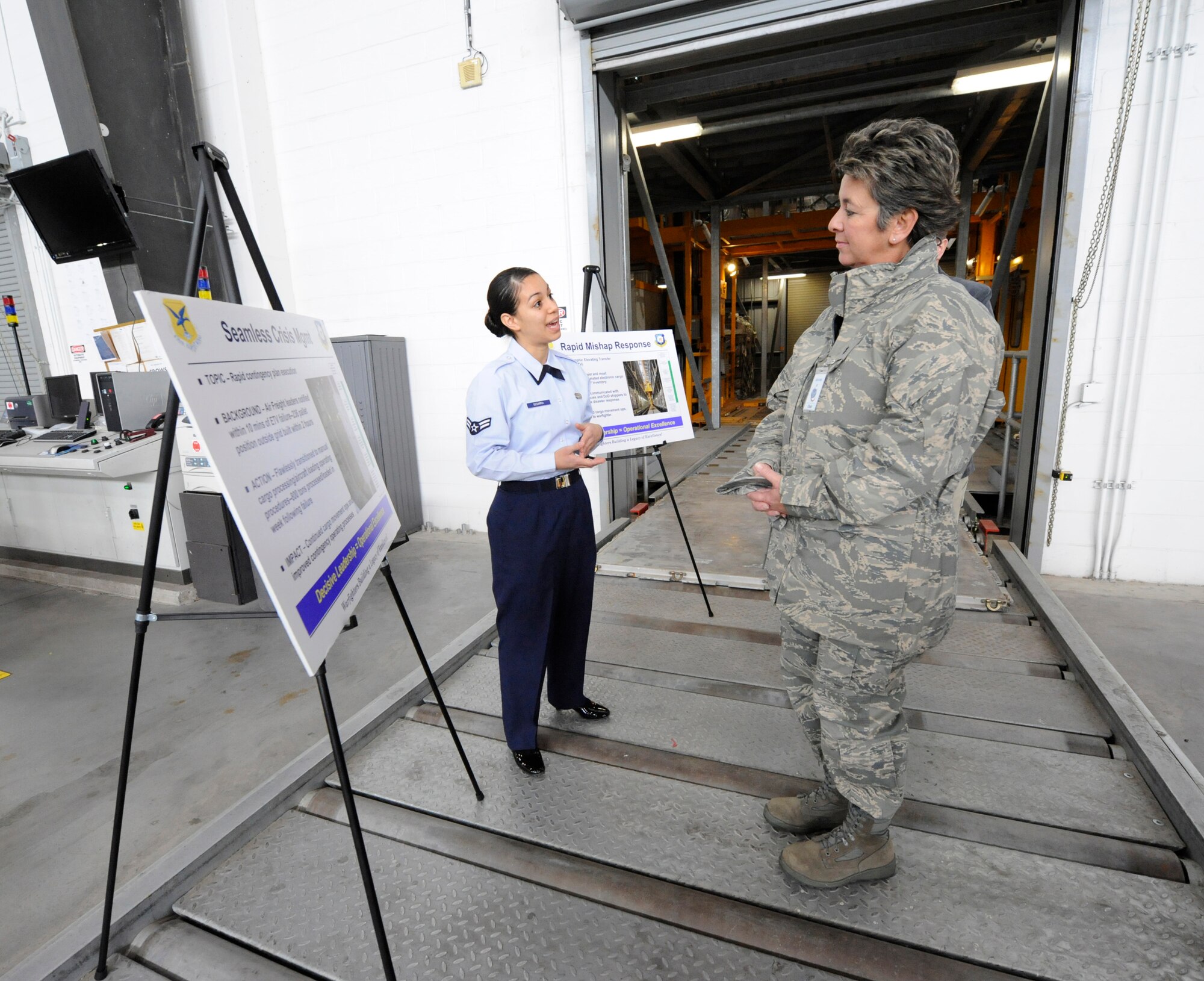 Airman First Class Dora Segarra, 436th Aerial Port Squadron, briefs Maj. Gen. Anita Gallentine, Air Force Installation Excellence Selection Board chief, about the Aerial Port’s response to the Elevating Transfer Vehicle mishap. Airman Segarra spoke about how even though the ETV was not operational, Aerial Port Airmen built a 263 pallet-grid yard in two hours and moved 800 tons of cargo in 96 hours with no delays. Dover AFB and Elmendorf AFB, Alaska, are the two finalists for the 2010 Commander-in-Chief’s Annual Award for Installation Excellence. (U.S. Air Force photo/Jason Minto)