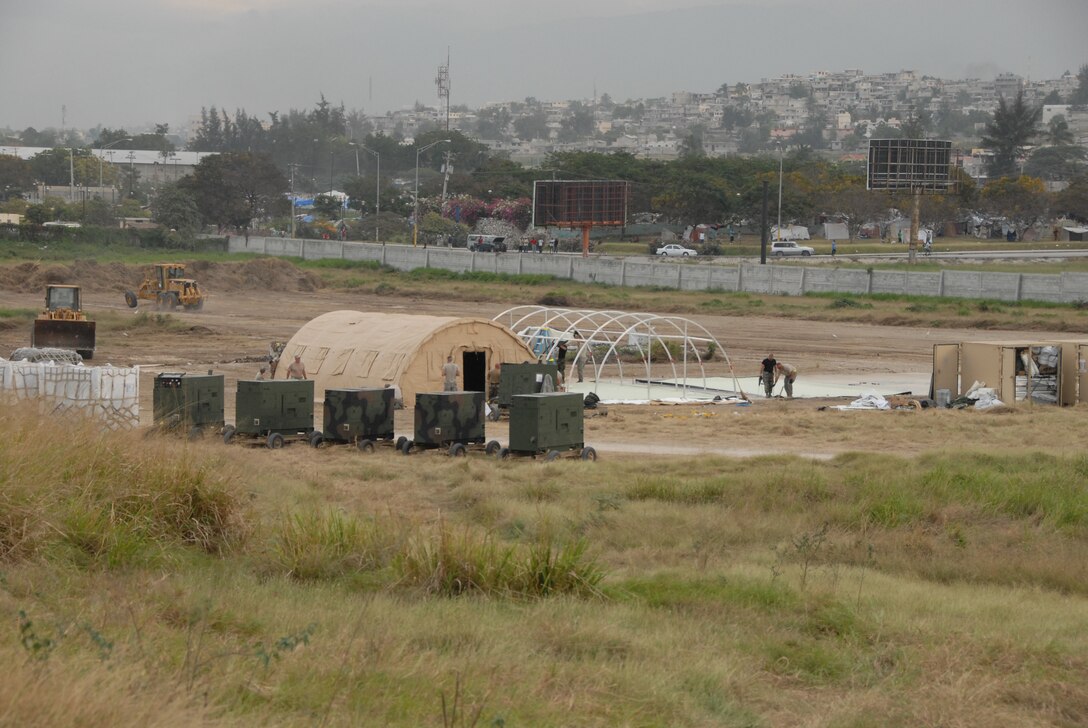 Members of the 190th and 184th Civil Engineering Squadron of the Kansas Air National Guard build an Expeditionary Medical Support (EMEDS) hospital.  There are 46 Kansas Air National Guardsmen deployed to build infrastructure for sustained operations in Haiti.