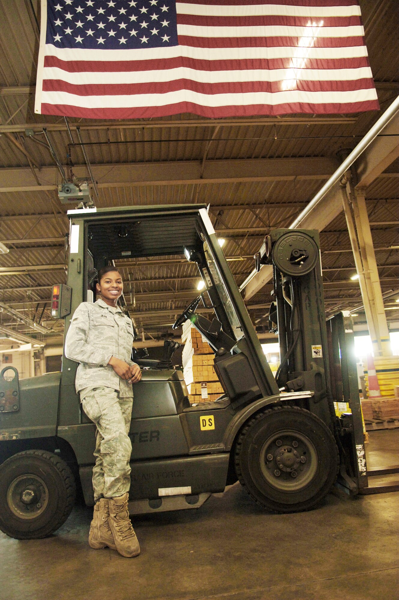 Airman 1st Class Samantha Jean is a traffic management apprentice with the 437th Aerial Port Squadron at Charleston Air Force Base, S.C. Originally from Haiti, she has recently become an American citizen and has been assisting the Haitian earthquake relief effort from Charleston AFB working in the packing and crating section of her squadron. (U.S. Air Force photo/Airman 1st Class Lauren Main)