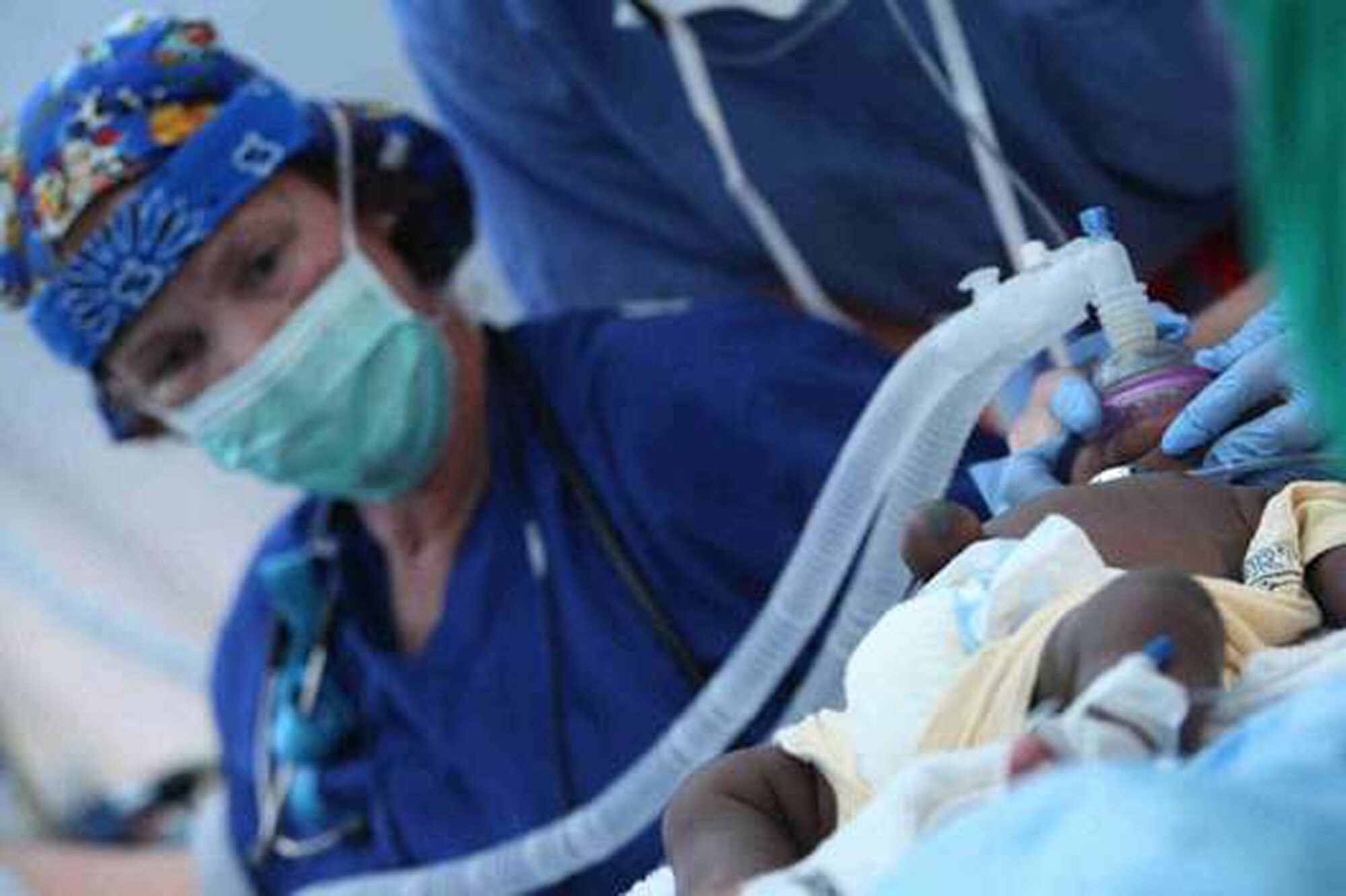 Col Paulette Schank joins with other American doctors and a Cuban doctor to operate on Frantz Andy Saintus, two-month-old who had an umbilical hernia. - (Courtesy photo//Suchat Pederson,The Delaware News Journal)