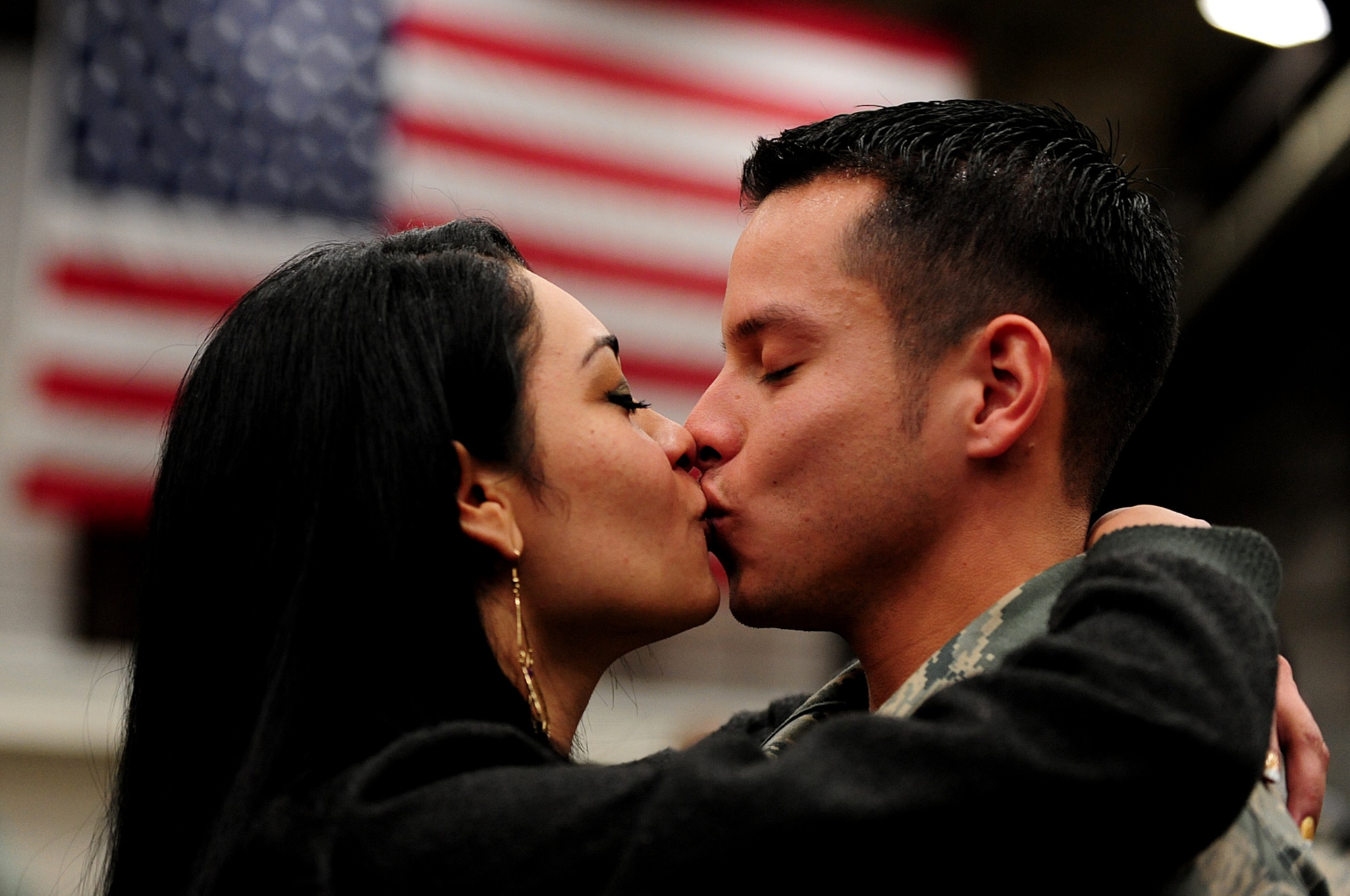 ELLSWORTH AIR FORCE BASE, S.D. --Senior Airman Jason Gonzalez-Carcamo, 28th Munitions Squadron weapons load crew member, kisses his fiancé after returning from deployment to Southwest Asia, Jan. 29. Airman Gonzalez-Carcamo provided support for Operations Iraqi Freedom and Enduring Freedom during his deployment. (U.S. Air Force photo/Airman 1st Class Joshua J. Seybert)