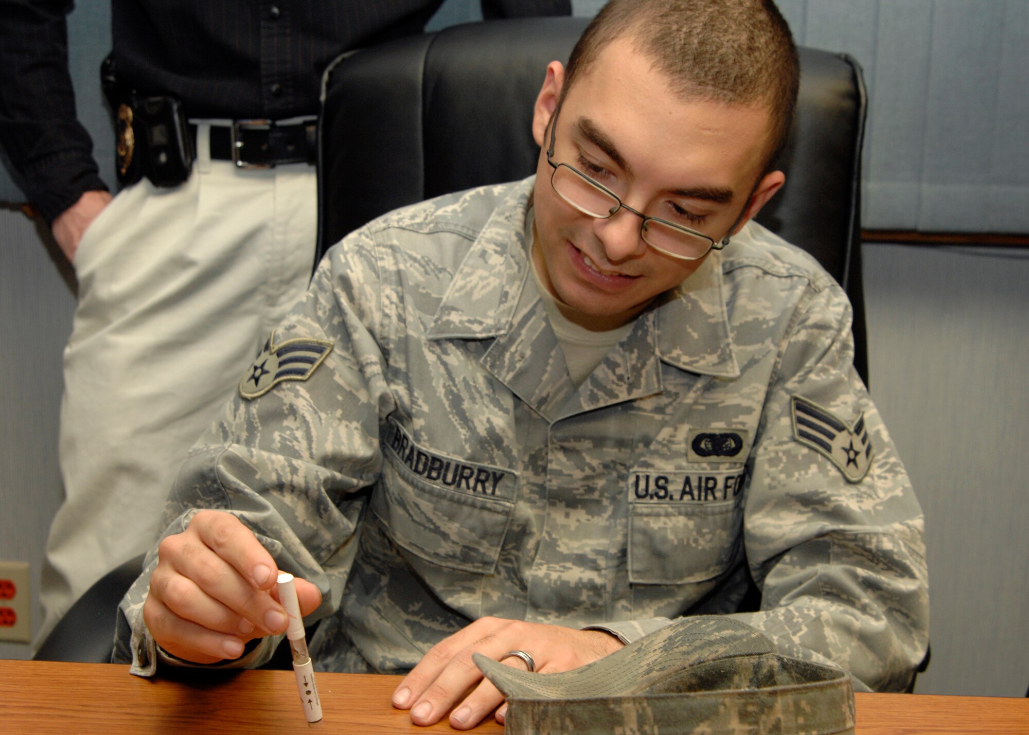 Senior Airman Bobby Bradburry, from the 22nd Communications Squadron, conducts a field drug test to verify narcotics, Jan. 22, 2010, during an OSI shadow program event. Airmen had the opportunity to learn about Air Force Office of Special Investigations agents, the AFOSI agency and experience some of the procedures they use on the job. Airmen and DoD employees interested in applying can call 316-759-4273. For more information about AFOSI, visit their public Web site at www.osi.andrews.af.mil. (U.S. Air Force photo/ Senior Airman Justin Shelton) 