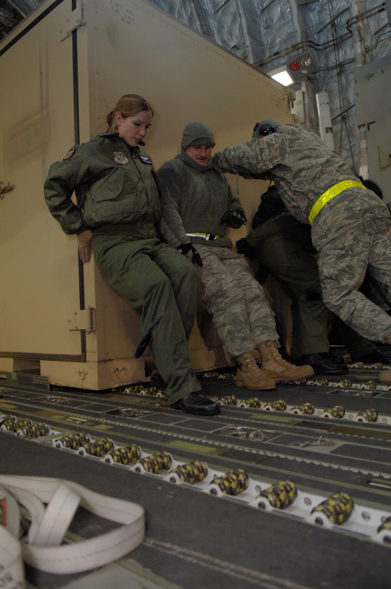 Airmen from the 179th Logistics Readiness Squadron and the 8th Airlift Squadron load crates of supplies onto a McChord AFB, Wash., C-17 in Toledo, Ohio, Jan. 30. The C-17 departed from Charleston AFB and made a brief three-hour stop to pick up supplies in Ohio to transport to Port-au-Prince, Haiti. The aircraft was loaded with several bins of equipment, pallets and two mobile lighting stations. (U.S. Air Force Photo/ Airman 1st Class Lauren Main)