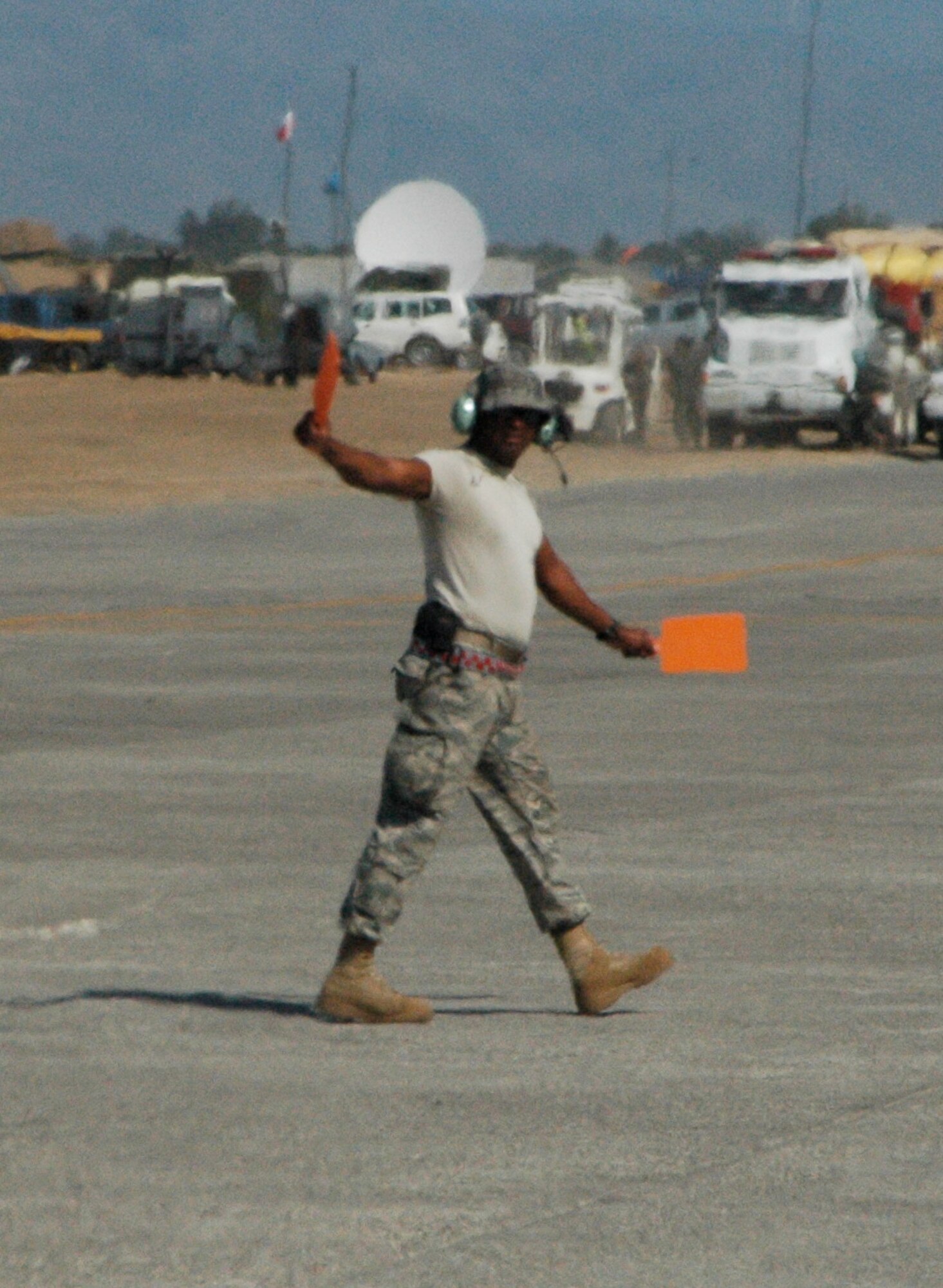 A U.S. Air Force Airmen ushers an Air Force Reserve C-130 Hercules and aircrew as it taxis for takeoff Jan. 30 at Toussaint Louverture International Airport in Port-au-Prince, Haiti. The crew earlier delivered dozens of packages of bottled water as well as aircraft parts to the Haitian capital. Approximately 50 Airmen from the AF Reserve's 302nd Airlift Wing are currently assigned to the 35th Expeditionary Airlift Squadron, which supports Air Expeditionary Force Coronet Oak at Muniz Air Base, Puerto Rico. The members are deployed in support of Haiti earthquake relief operations. (U.S. Air Force photo/Staff Sgt. Stephen J. Collier)