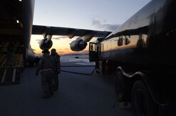 Airmen from the 179th Logistics Readiness Squadron refuel a McChord AFB, Wash., C-17 in Toledo, Ohio, Jan. 30. The C-17 took off from Charleston AFB and made a brief three-hour stop in Ohio. During that time, numerous pallets of supplies were loaded onto the C-17 for transport to Port-au-Prince, Haiti, in support of Operation Unified Response. (U.S. Air Force Photo/Airman 1st Class Lauren Main)