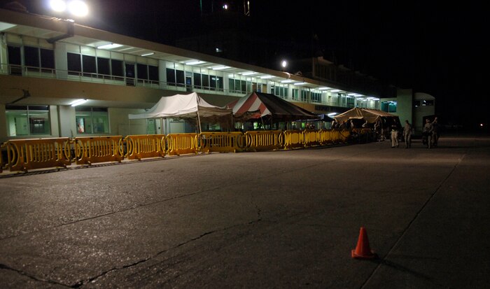 The vacant airport in Port-au-Prince, Haiti, is lit by few exterior lights. During the day, the area is regularly filled with those waiting to board aircraft for evacuation to the U.S. Despite the four-day hold that was placed on the transportation of evacuees, many still await to seek refuge from the destruction. (U.S. Air Force Photo/Airman 1st Class Lauren Main)