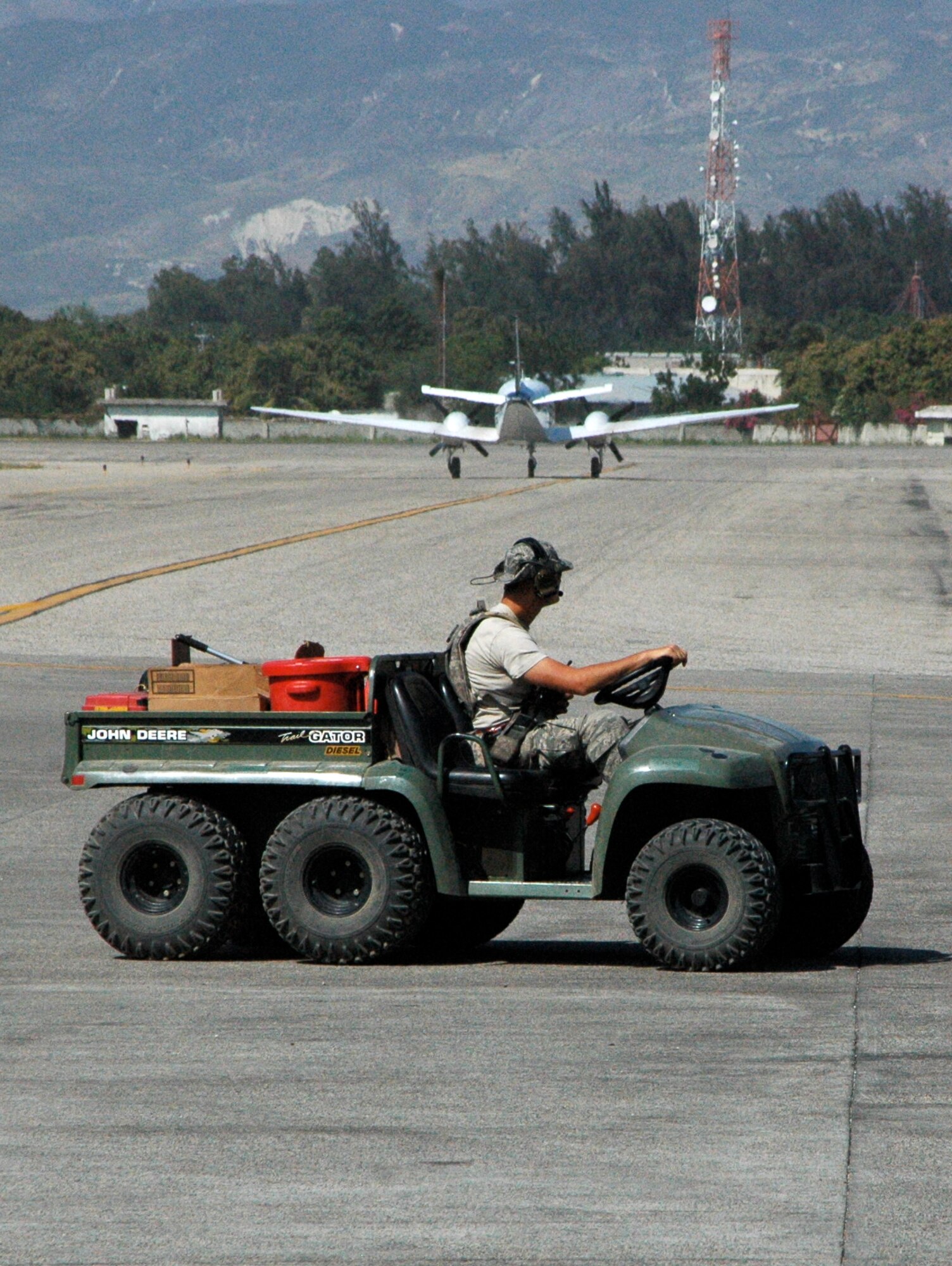 U.S. Air Force aerial transporters race across the flightline Jan. 30 at Toussaint Louverture International Airport in Port-au-Prince, Haiti. Aerial transporters there are on 24 hour operations, supporting the more than 130 military and commercial aircraft from the U.S. and other countries arriving in Haiti daily providing relief support. (U.S. Air Force photo/Staff Sgt. Stephen J. Collier)