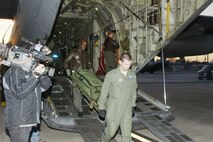 Tech. Sgt. Jason Wade and Master Sgt. Jon Wallace offload medical equipment they used to provide critical assistance to Haitians Jan. 31, 2010, at Dobbins Air Reserve Base, Ga. The crew returned from a two-week deployment in support of Operation Unified Response. Sergeants Wade and Wallace are 94th Aeromedical Evacuation Squadron medical technicians. (U.S. Air Force photo/Don Peek)