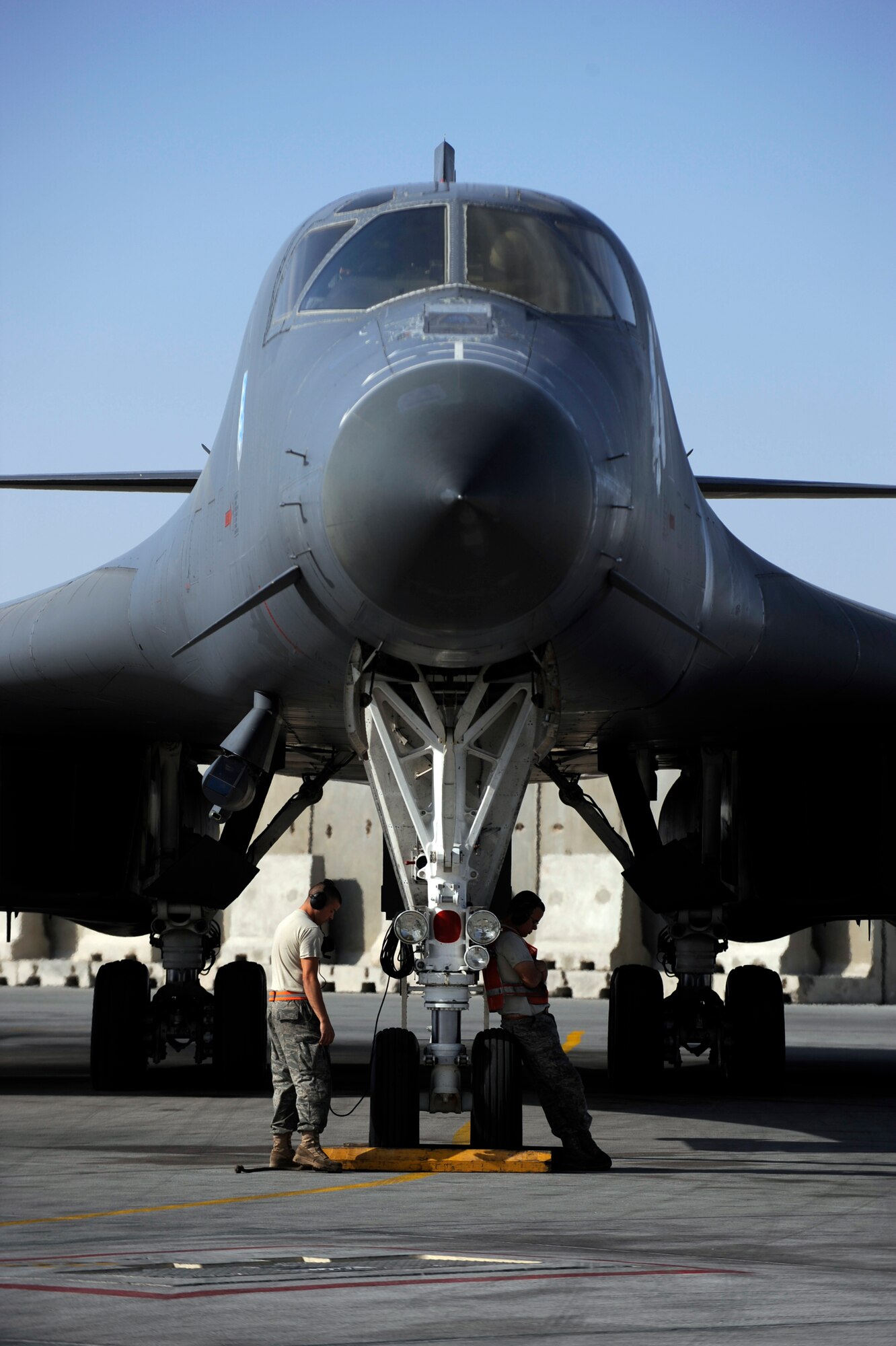 Crew chiefs wait for a B-1B Lancer aircrew to accomplish system checks prior to take off Jan. 23, 2010, at an air base in Southwest Asia. The crew chiefs are assigned to the 37th Aircraft Maintenance Unit. (U.S. Air Force photo/Staff Sgt. Manuel J. Martinez)