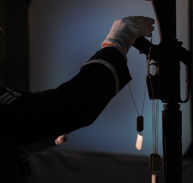 MOODY AIR FORCE BASE, Ga. -- A member of the Moody Air Force Base Honor Guard places the dog tags of fallen Airmen on an M-16 assault rifle during the 2009 Annual Awards Ceremony held at the James H. Rainwater Conference Center in Valdosta, Ga., Jan. 30. The memorial was dedicated to the Airmen who lost their lives fighting for freedom and for the families of those Airmen. (U.S. Air Force photo by Airman 1st Class Benjamin Wiseman)