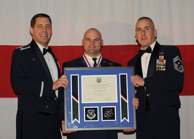 MOODY AIR FORCE BASE, Ga. -- Tech. Sgt. Brandon Livingston, 93rd Air Ground Operations Wing Non-Commissioned Officer of the Year Award winner, poses for a photo with (left) Col. John Horner, 93rd AGOW commander, and (right) Command Chief Master Sgt. Thomas Vallely, 93rd AGOW command chief master sergeant, during the 2009 Annual Awards Ceremony held at the James H. Rainwater Conference Center in Valdosta, Ga., Jan. 30. (U.S. Air Force photo by Senior Airman Gina Chiaverotti-Paige)