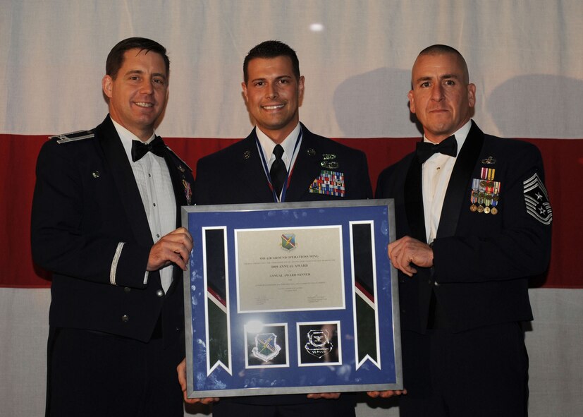 MOODY AIR FORCE BASE, Ga. -- Staff Sgt. Joseph R. Aton, 93rd Air Ground Operations Wing Airman of the Year Award winner, poses for a photo with (left) Col. John Horner, 93rd AGOW commander, and (right) Command Chief Master Sgt. Thomas Vallely, 93rd AGOW command chief master sergeant, during the 2009 Annual Awards Ceremony held at the James H. Rainwater Conference Center in Valdosta, Ga., Jan. 30. (U.S. Air Force photo by Senior Airman Gina Chiaverotti-Paige)