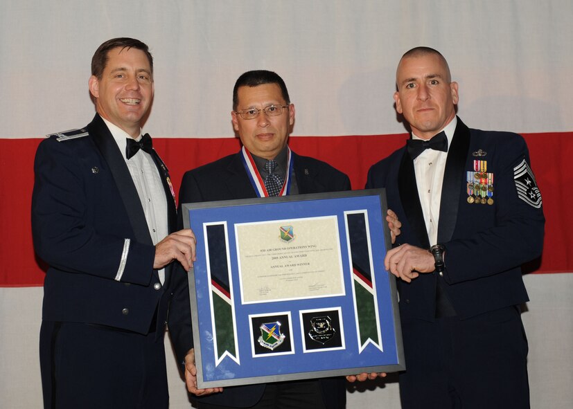 MOODY AIR FORCE BASE, Ga. -- Robert LeFever, 93rd Air Ground Operations Wing Civilian of the Year Professional and Analytical Award winner, poses for a photo with (left) Col. John Horner, 93rd AGOW commander, and (right) Command Chief Master Sgt. Thomas Vallely, 93rd AGOW command chief master sergeant, during the 2009 Annual Awards Ceremony held at the James H. Rainwater Conference Center in Valdosta, Ga., Jan. 30. (U.S. Air Force photo by Senior Airman Gina Chiaverotti-Paige)