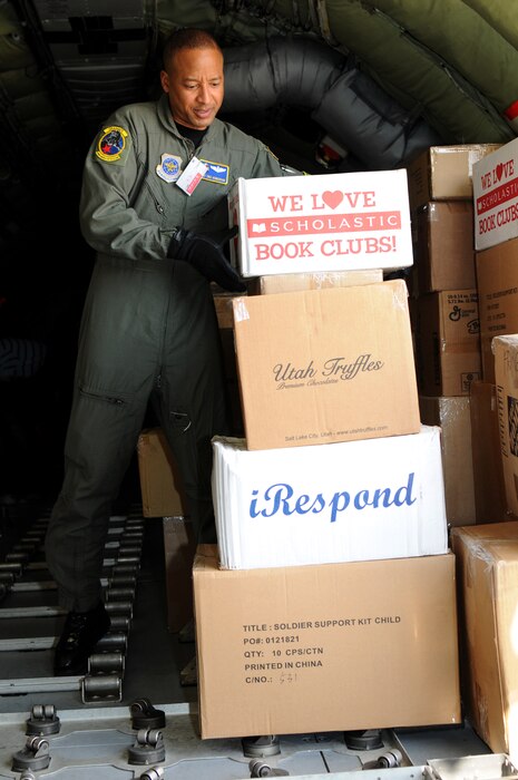 Master Sgt. Eric Henderson, a boom operator from the 151st Operations Group, unloads school supplies for a Moroccan orphanage Jan. 24. The 50 school kits, which were assembled and donated by spouses of the Utah National Guard's senior enlisted leaders, were flown on a Utah ANG KC-135. The aircraft will also participate in the Aeroexpo Marrakech 2010 scheduled for January 27 to 30 in Morocco. U.S. Air Force photo by Airman 1st Class Lillian Chatwin (Unclassified)