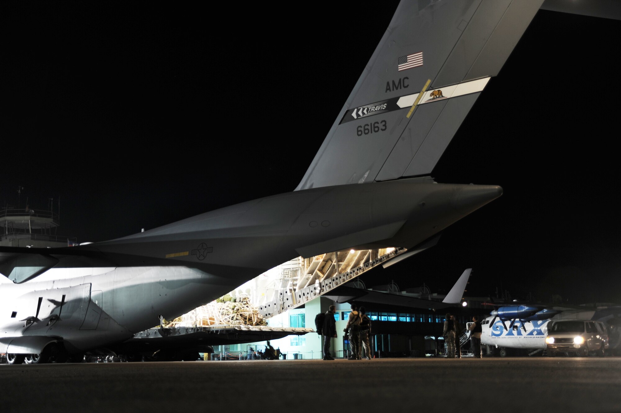A special mission shipment of money waits to be unloaded from a C-17 Globemaster III from Travis Air Force Base, Calif., Jan. 22, 2010, at Port-au-Prince, Haiti. The cargo was sent from Charleston AFB, S.C., along with members of security forces and intelligence squadrons to support Operation Unified Response. (U.S. Air Force photo/Senior Airman Katie Gieratz)