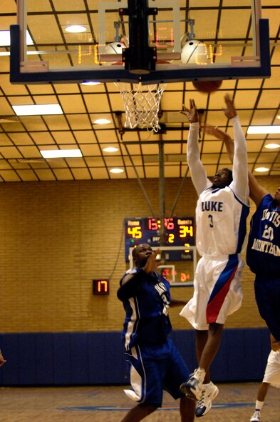 Luke team member David Mebane, former service member, goes to rebound the ball during the Varsity Basketball Game against Davis-Monthan at Luke Air Force Base, Ariz, Jan 30, 2009. (U.S. Air Force Photo by Staff Sgt. Jason Colbert)