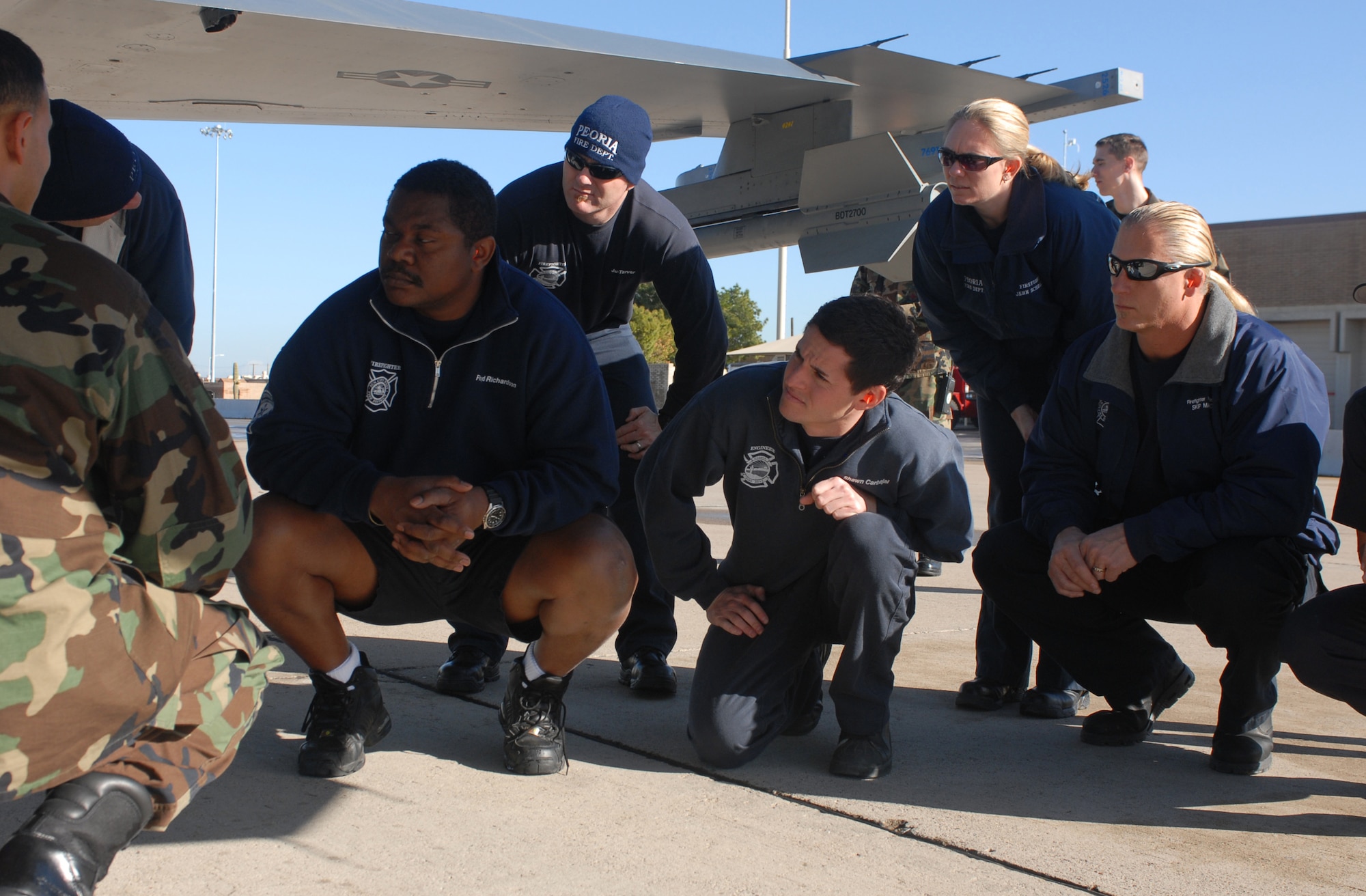 Staff Sgt. Michael Alvarado, 56th Civil Engineer Squadron firefighter, briefs firefighters from Peoria and Sun City during an F-16 safety training course Jan. 20. (U.S. Air Force photo/Airman 1st Class Sandra Welch)