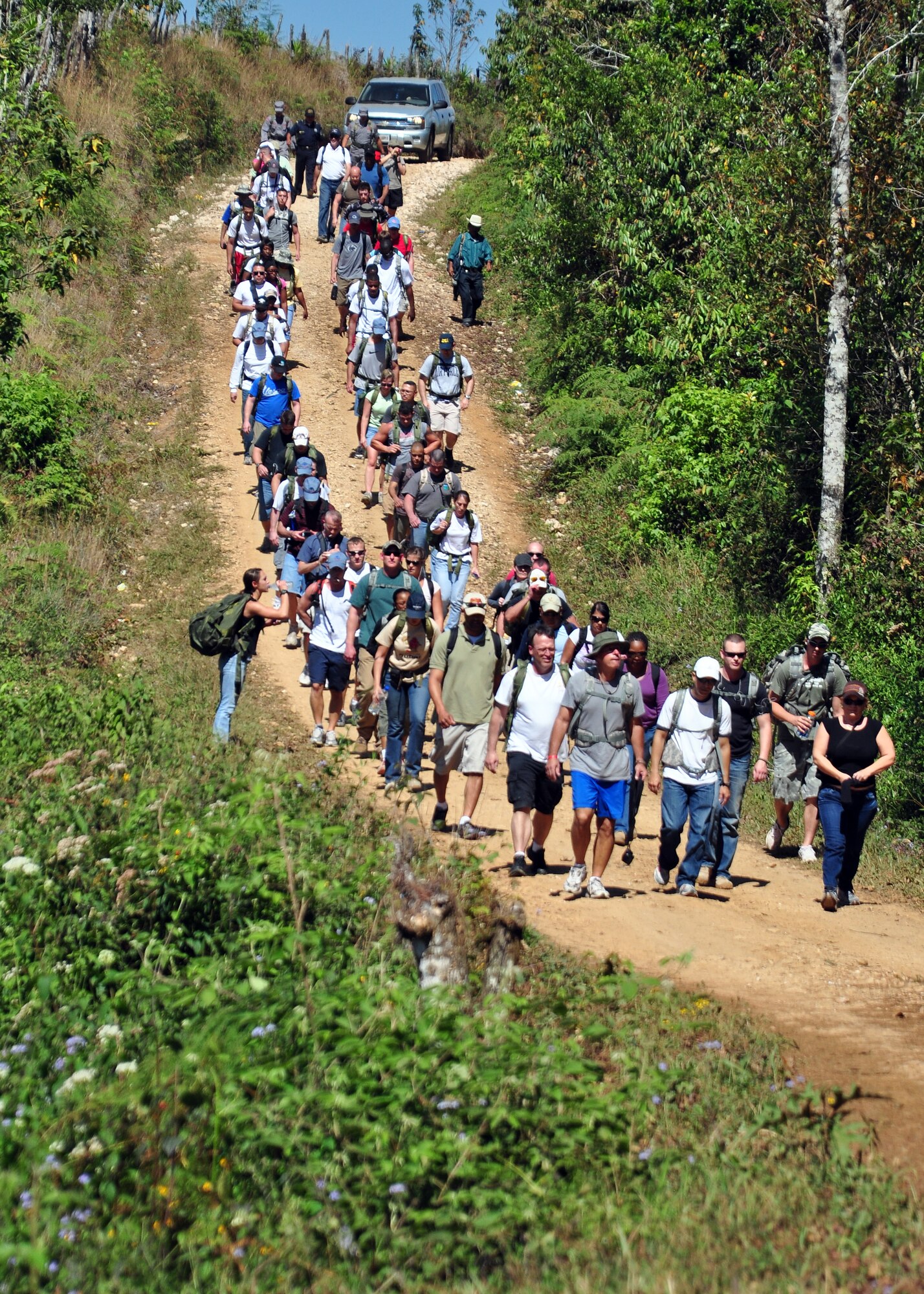More than 70 Team Soto Cano members participate in a Chapel Hike Jan. 23 to provide assistance to an isolated village near Soto Cano Air Base, Honduras. The members hiked nearly four miles carrying more than a ton of food and supplies to the remote community. (U.S. Air Force Photo/Staff Sgt. Bryan Franks)