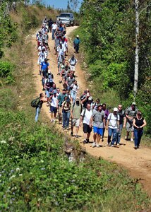 More than 70 Team Soto Cano members participate in a Chapel Hike Jan. 23 to provide assistance to an isolated village near Soto Cano Air Base, Honduras. The members hiked nearly four miles carrying more than a ton of food and supplies to the remote community. (U.S. Air Force Photo/Staff Sgt. Bryan Franks)