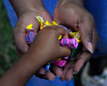 Team Soto Cano members pass out candy during a Chapel Hike Jan. 23 in Cinacla, Honduras. The members from Soto Cano Air Base, Honduras hiked nearly four miles carrying more than a ton of food and supplies to the remote community of 300. (U.S. Air Force Photo/Staff Sgt. Bryan Franks)