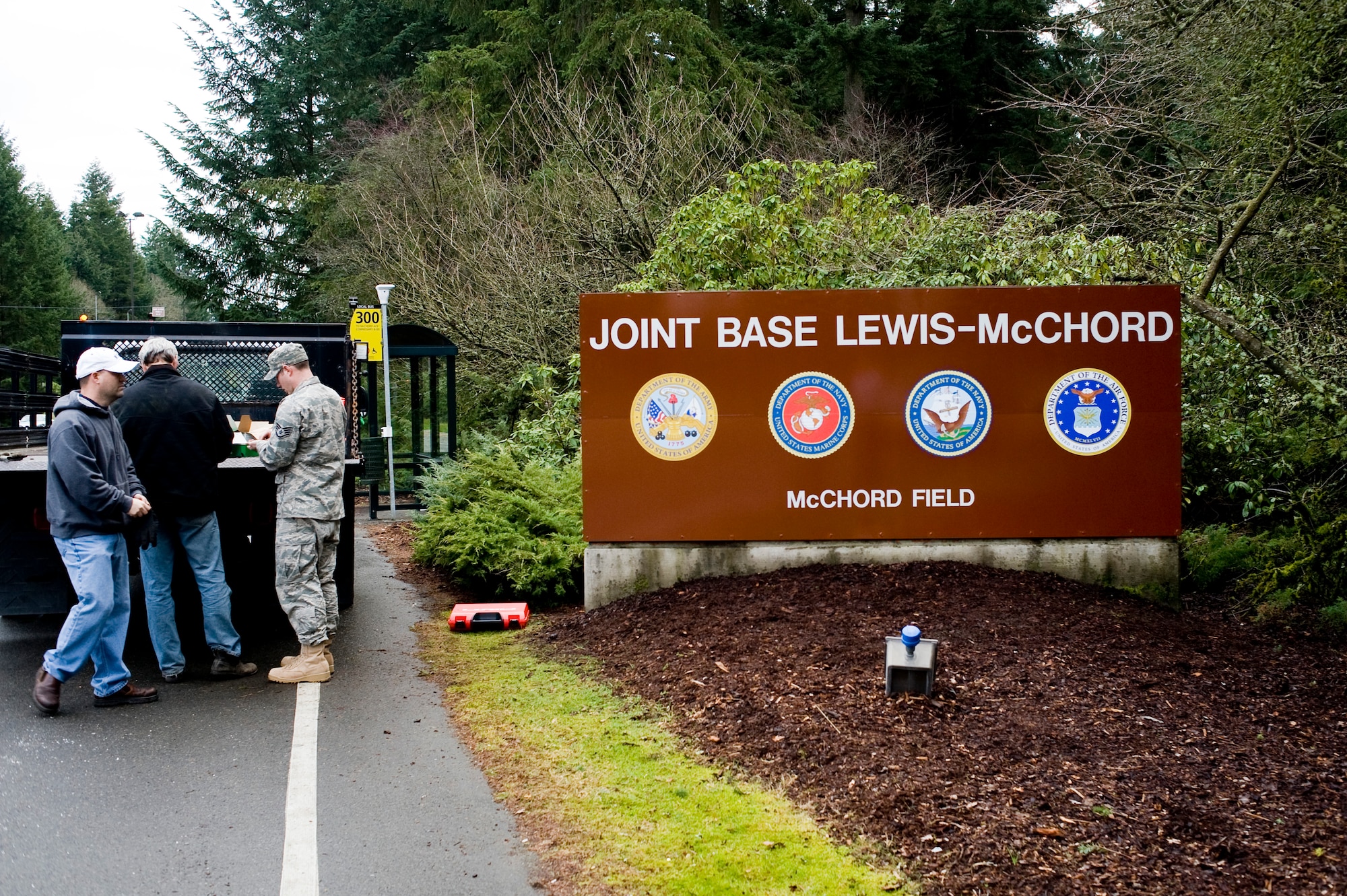 Members of the 62nd Civil Engineer Squadron, pack up after installing the new Joint Base Lewis-McChord sign at the entrance of the base Sunday. (U.S. Air Force Photo/Abner Guzman)