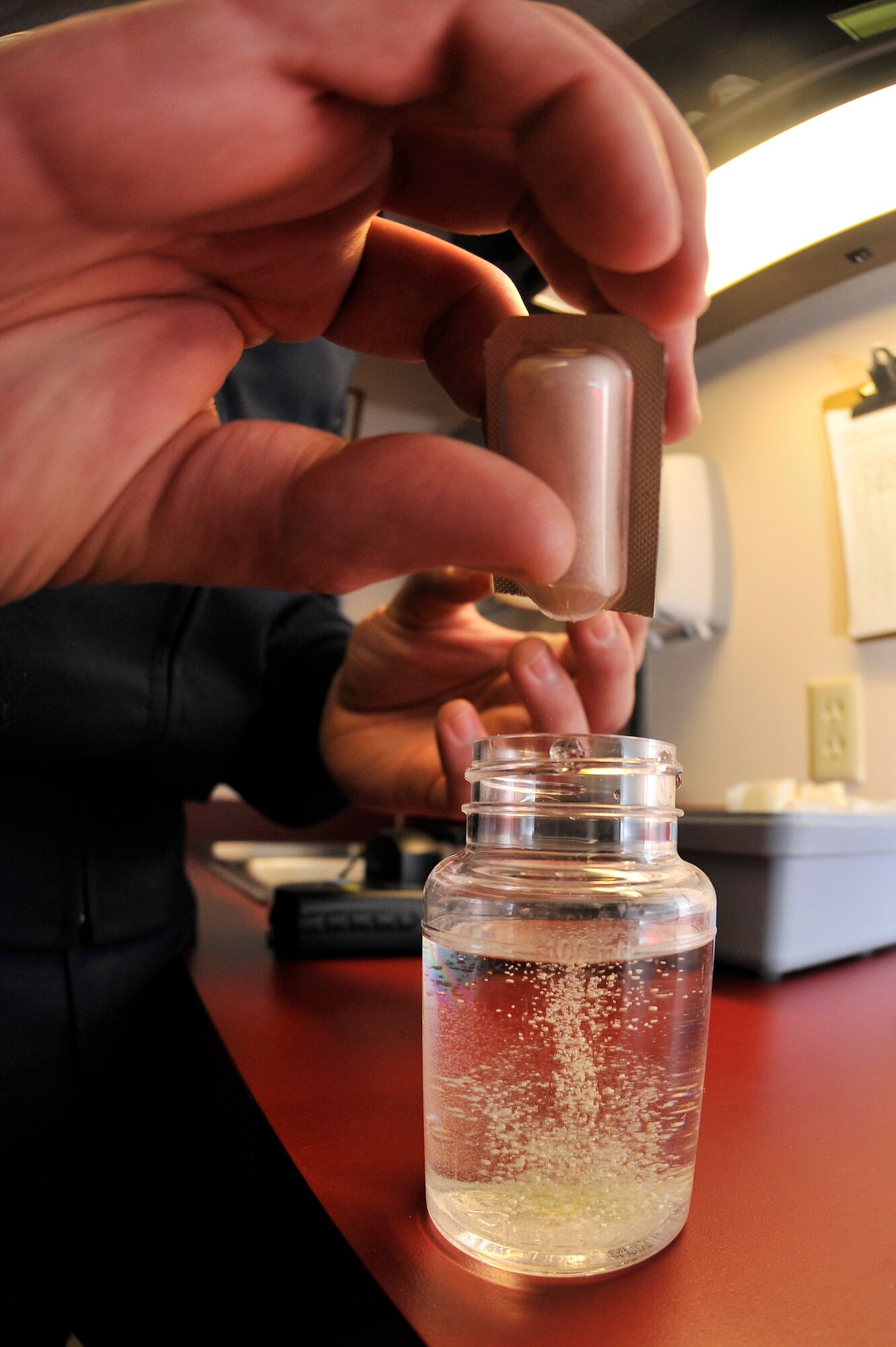 Airman 1st Class Samuel Bergh adds bacteria food to a water sample Feb. 1, 2010, Eielson Air Force Base, Alaska. After incubating the water sample for 24-hours, the water sample will either read positive or negative for contamination. Airman Bergh is bioenvironmental technician assigned to the 354th Medical Operations Squadron. (U.S. Air Force photo/Staff Sgt. Christopher Boitz)