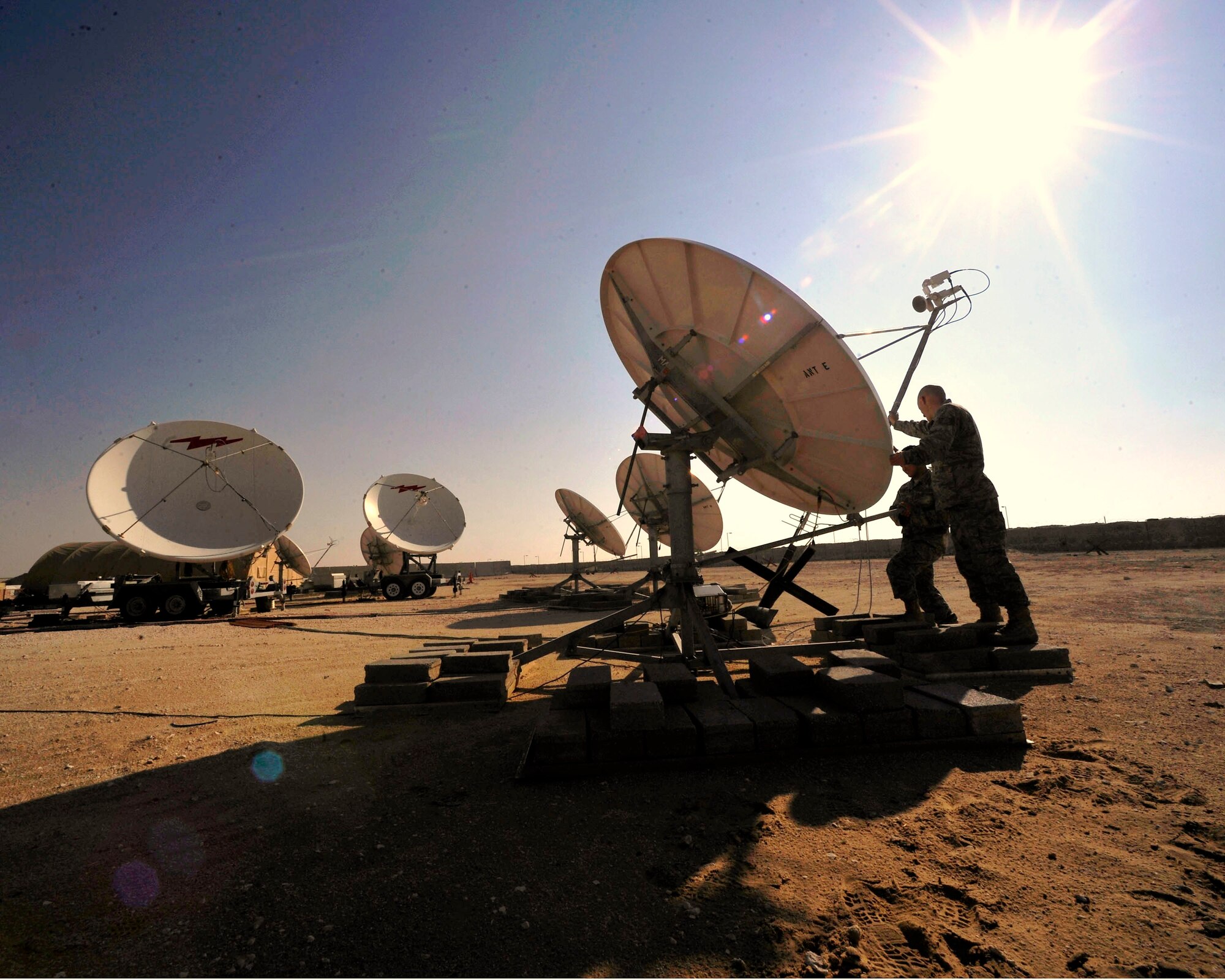 Airmen of the 16th and 380th Space Control Squadron re-orient an antenna used to detect interference on mission critical satellite communication links in Southwest Asia.  (Air Force photo by Staff Sgt. Angelita Lawrence)

