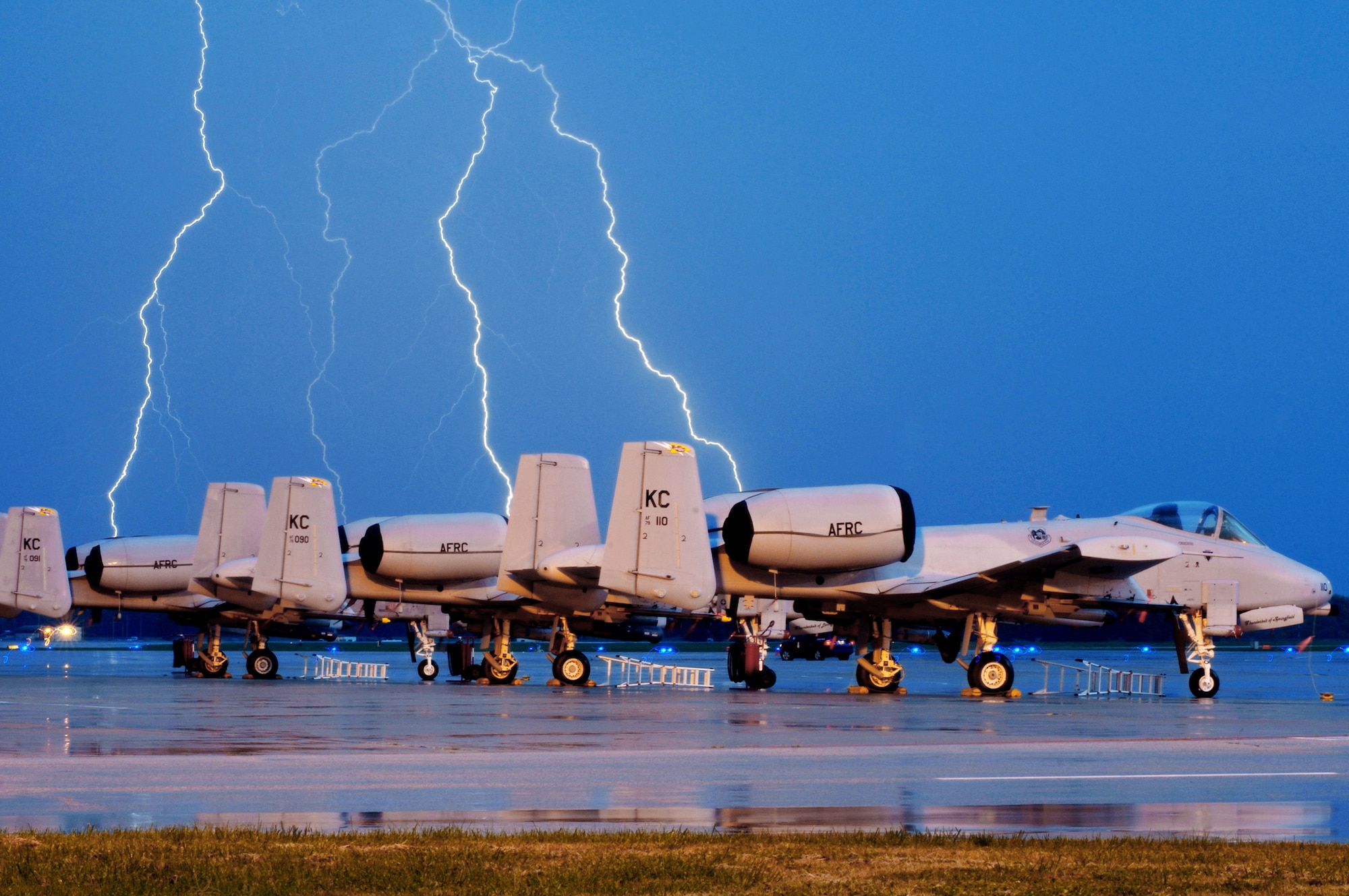 Lighting strikes behind A-10 Thunderbolt IIs on the Whiteman Air Force Base, Mo., flightline during an early morning thunderstorm Oct. 20, 2009. The 442nd Fighter Wing maintains a fleet of 27 A-10s. (U.S. Air Force photo/Senior Airman Kenny Holston)