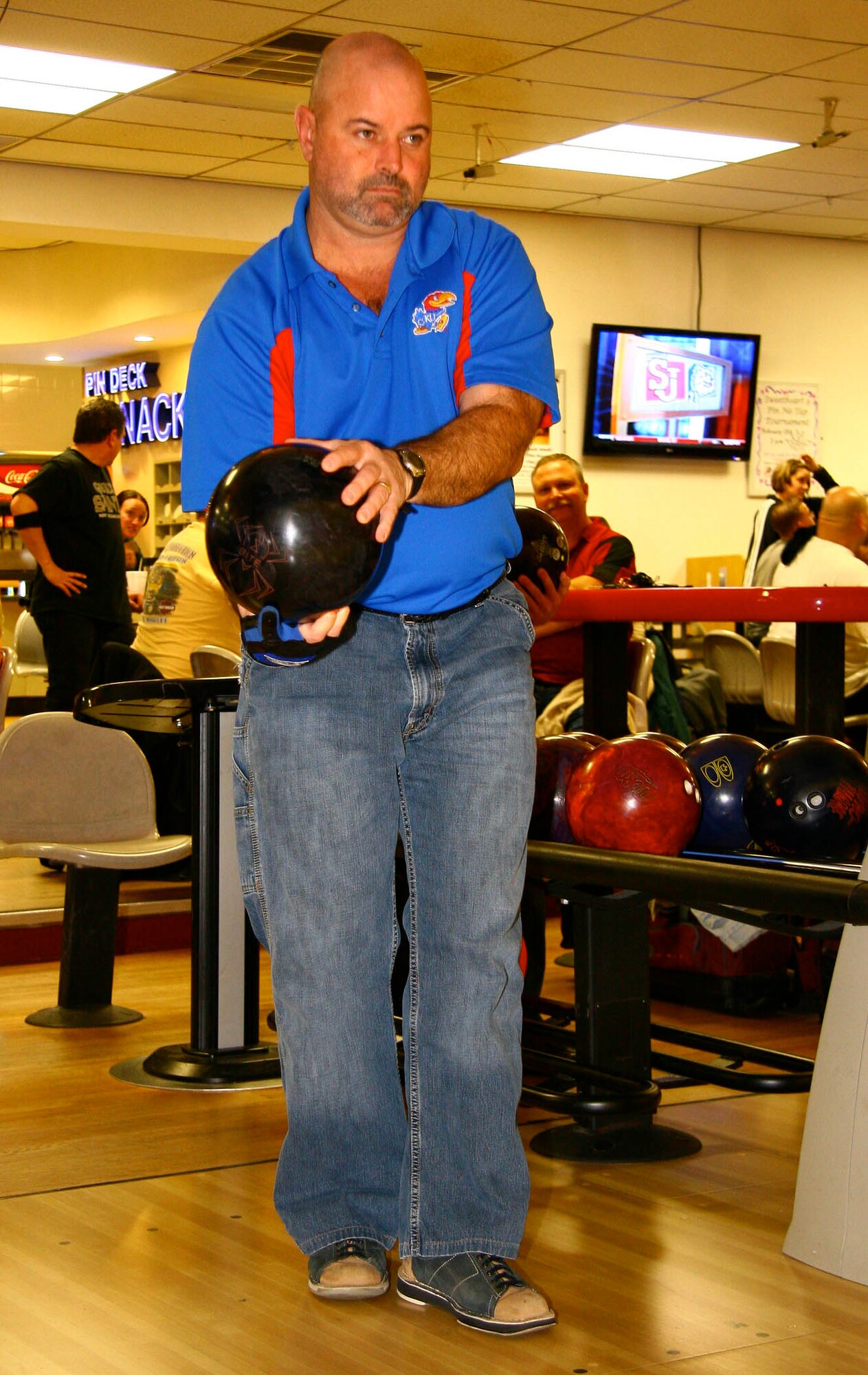 Long-time Tinker bowler Merle Norman takes a look down the lane at the Tinker Bowling Alley recently. Norman has several 300 games and 800 series to his name and is part of the tight-knit bowling community on base.(Air Force photo by Margo Wright)
