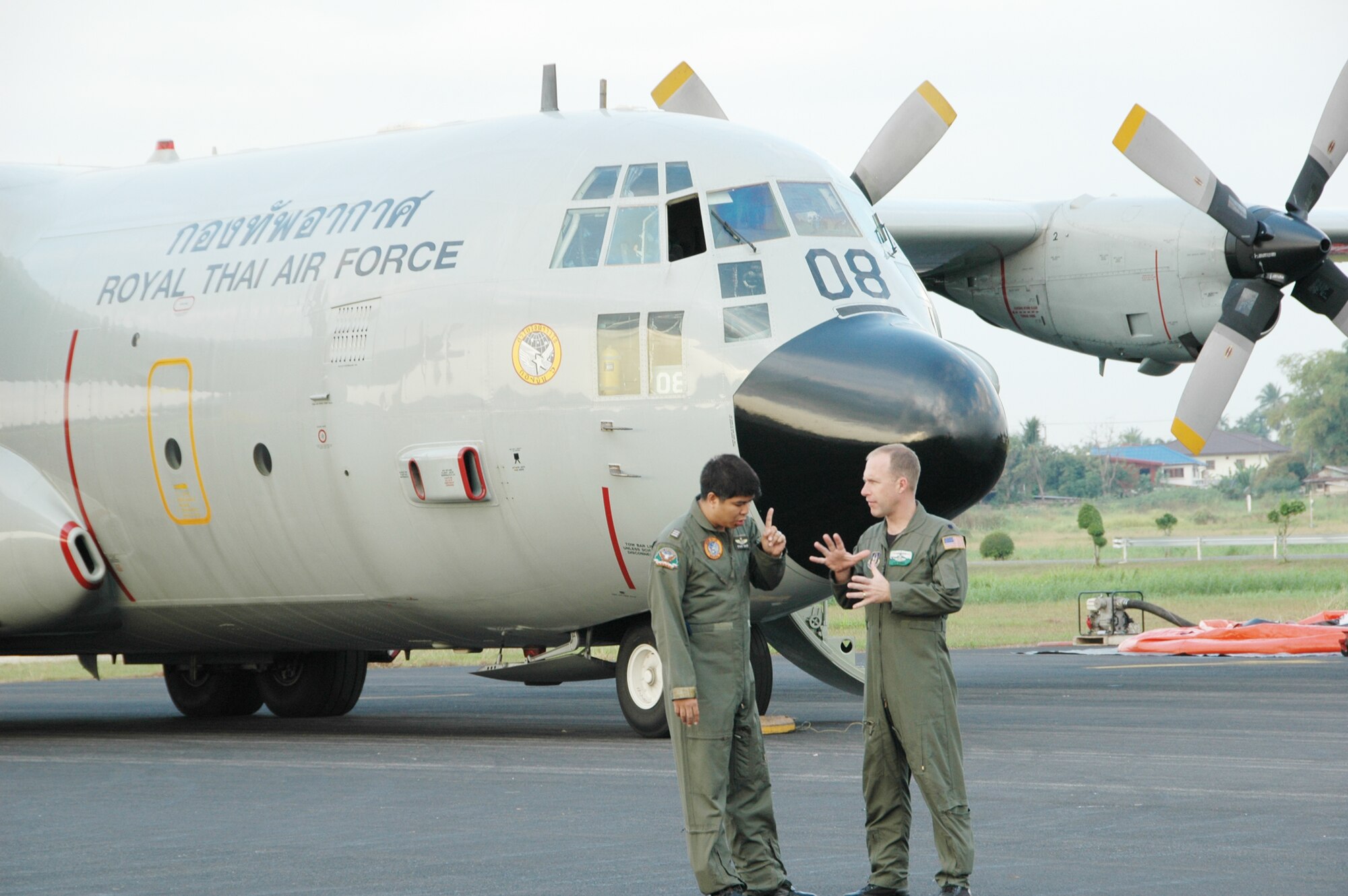 Lt. Col. James Banker discusses the challenges of flying the aerial firefighting mission with Squadron Leader Saraphongse Dibavadi, prior to a training mission involving a wet drop Jan. 25, 2010 at Phitsanulok Royal Thai Air Force Base, Thailand. Colonel Banker is the chief of current operations with the Air Force Reserve's 302nd Airlift Wing based at Peterson AFB, Colo. Mr. Dibavadi is the 601squadron deputy commander for the Royal Thai Air Force. (U.S. Air Force photo/Capt. Jody L. Ritchie)
