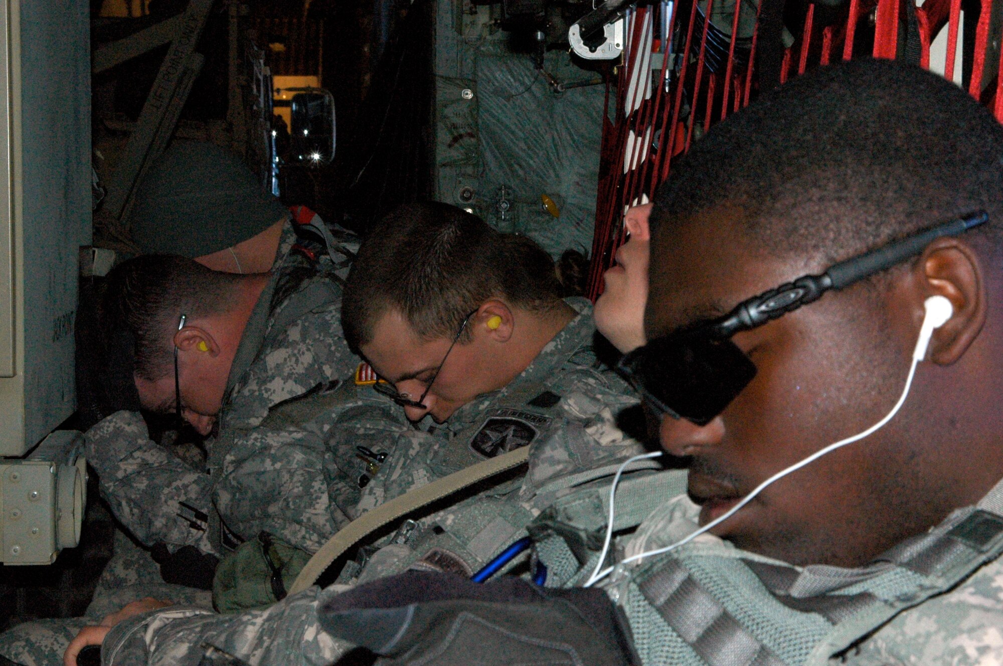 Army Spc. Julian Johnson (right) and other Soldiers from the 82nd Airborne Division get some rest Jan. 27, 2010, enroute to Port-au-Prince, Haiti. Specialist Johnson and more than 10 Soldiers in his unit flew on an Air Force Reserve C-130 Hercules to Haiti where they deployed in support of earthquake relief operations. Approximately 50 members of the 133rd Airlift Wing are deployed to Muniz Air Base, Puerto Rico, in support of Coronet Oak, operated by the 35th Expeditionary Airlift Squadron. (U.S. Air Force photo/Staff Sgt. Stephen J. Collier)