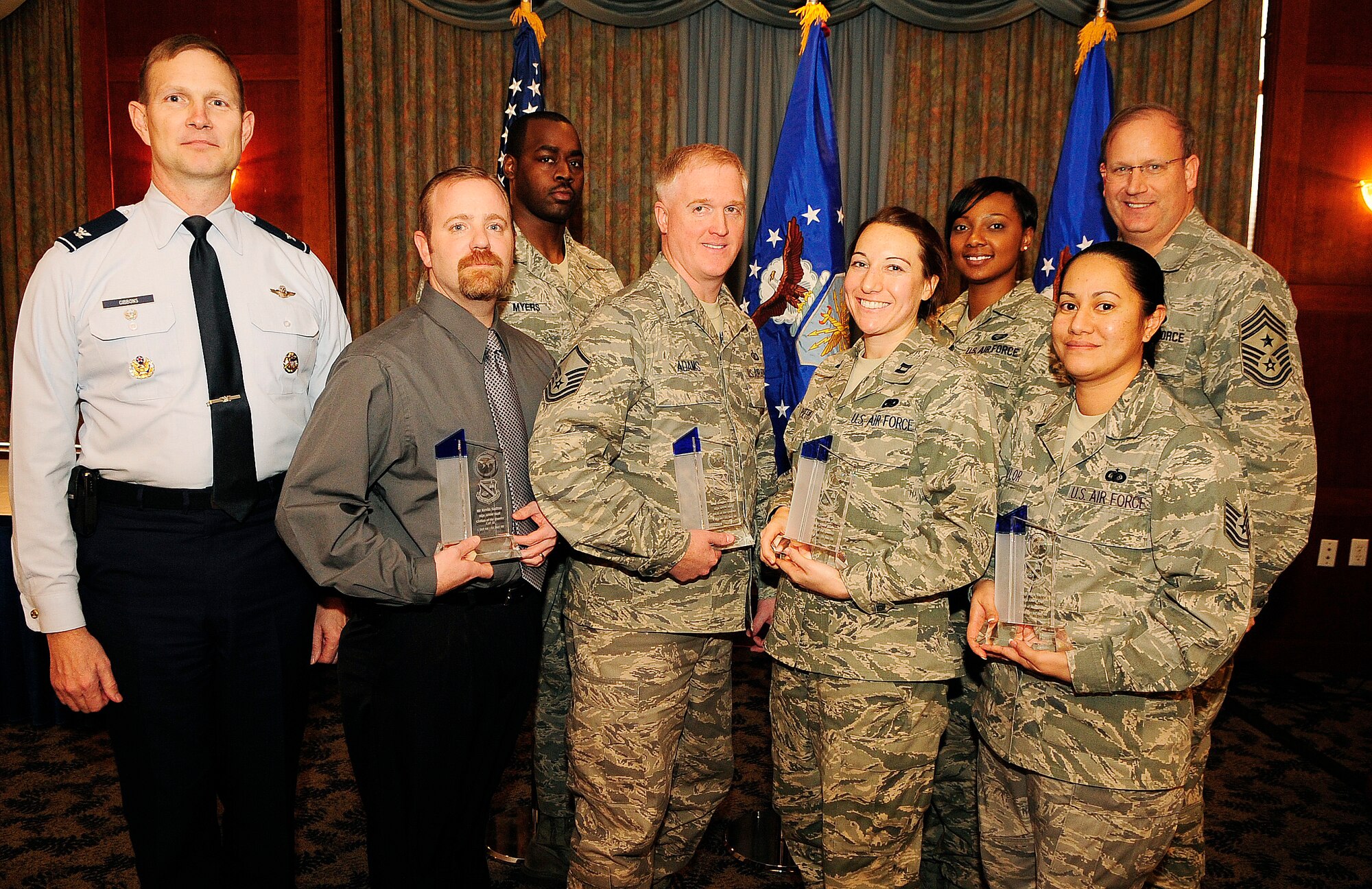 Colonel Gibbons, Vice Commander, Air Force District of Washington and Command Chief Master Sgt. Pat Battenberg share a moment with the AFDW fourth quarter award winners. From left to right are Col. Phillip Gibbons, Mr. Kevin Sutton, Staff Sgt. Jayson Myers, Master Sgt. Douglas Adams, Capt. Melonie San Pietro, Airman 1st Class Shenna Edwards, Tech. Sgt. Rica Taylor and Command Chief Master Sgt. Pat Battenberg. Not pictured is Ms. Charonda Boone.
(U.S Air Force photo by Staff Sgt. Corenthia Fennell) 
