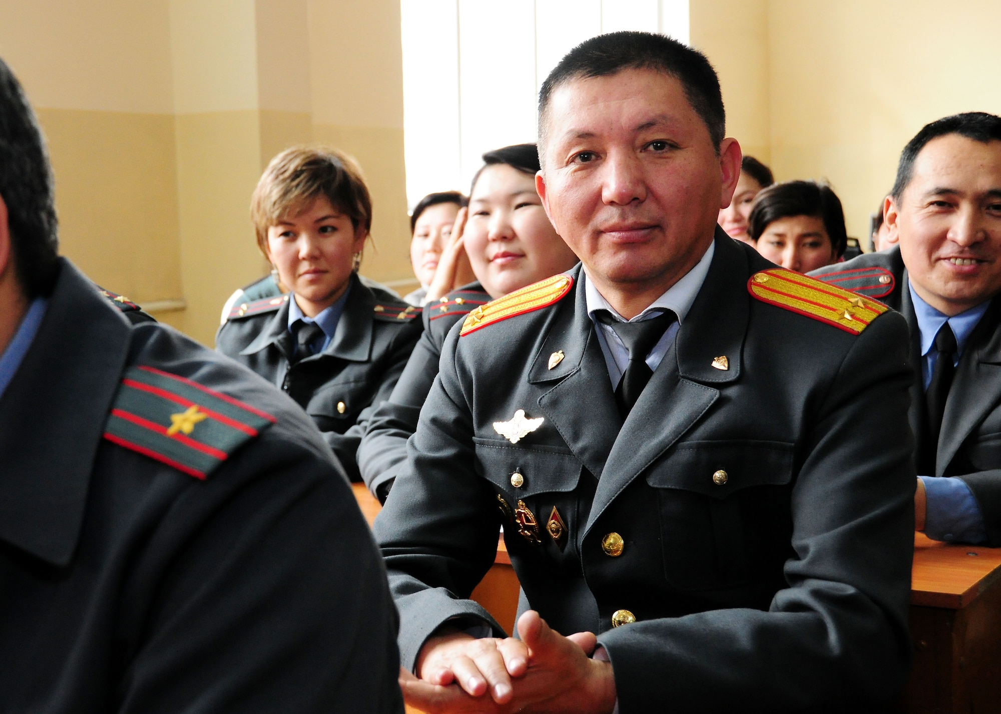 Police Academy instructor, Abdyrazak Turdubaev, applauds after a set by "Celtic Aire," the U.S. Air Forces Central Public Affairs band, at the Academy in Bishkek, Kyrgyzstan, Jan. 28, 2010. The Academy performance was one of five performances the band will play in the local Kyrgyz community. (U.S. Air Force photo/Senior Airman Nichelle Anderson/released)