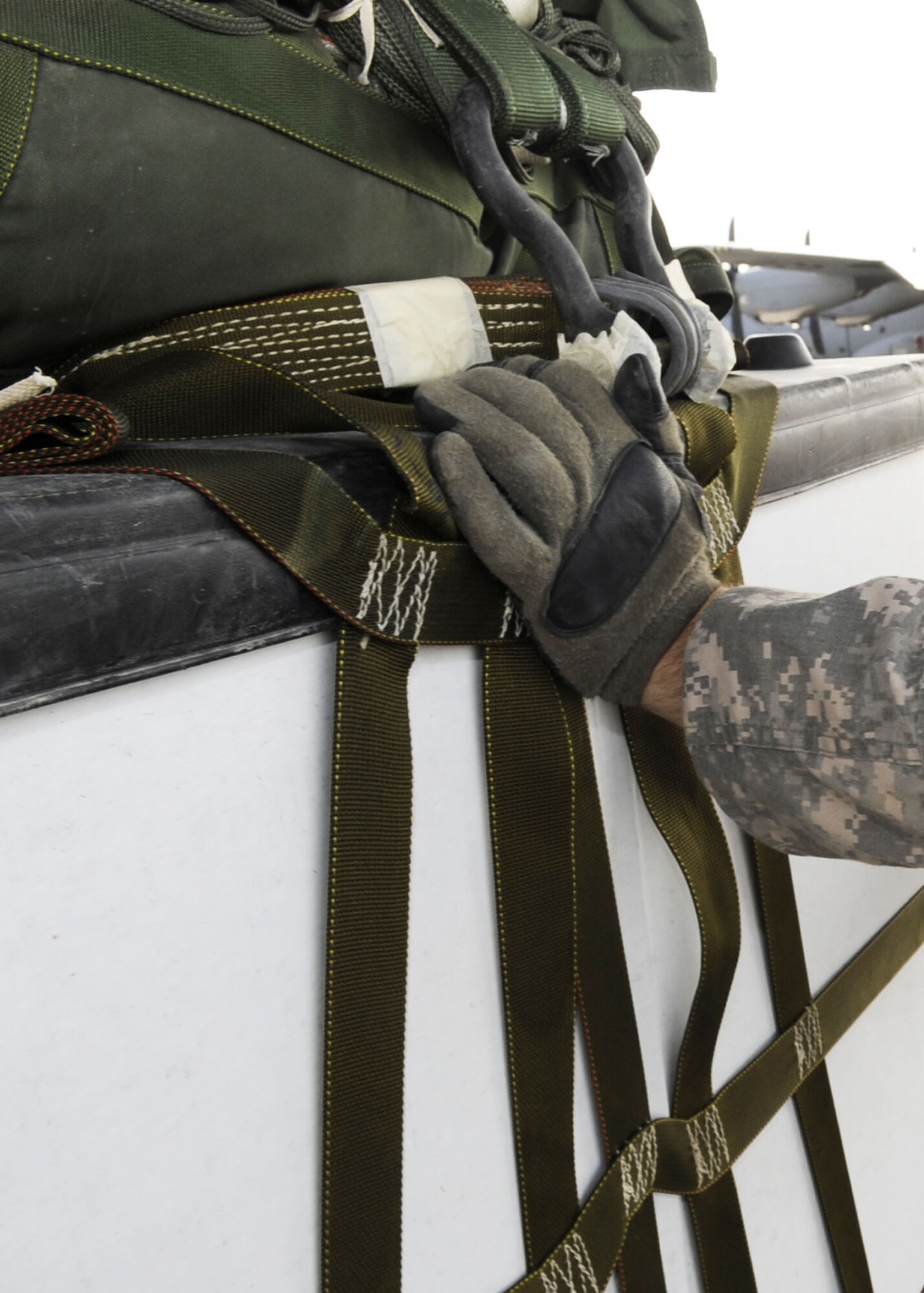 A Soldier pushes a containerized delivery system onto a C-130J Super Hercules here, Jan. 29, 2010. The 82nd Airborne Corps’ new rigging facility on Kandahar Airfield will allow Soldiers to build more CDS bundles filled with equipment and supplies needed to be airdropped to forward operating bases within Afghanistan. The 772nd Expeditionary Airlift Squadron's airdrop support will then be increased by 250 percent. (U.S. Air Force photo/Senior Airman Nancy Hooks/Released) 