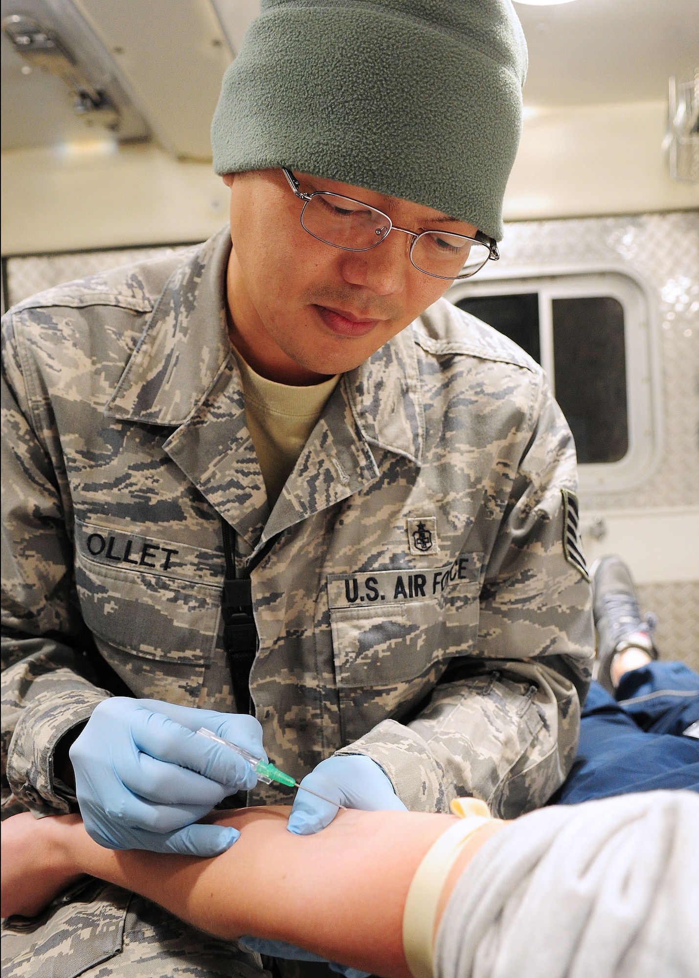 Tech. Sgt. Lemuel Ollet, 376th Expeditionary Medical Group aero medical technician, demonstrates how to put an IV in a patient?s arm in the back of an ambulance at the Transit Center at Manas, Kyrgyzstan, Feb. 1. Sergeant Ollet was on duty Jan. 18 when Jamie Morris, a Peace Corps volunteer in Central Asia, was transported to the Transit Center here for medical treatment after an automobile accident. She was stabilized and air evacuated back to the United States, where she is recovering. (U.S. Air Force photo/Senior Airman Nichelle Anderson/Released)