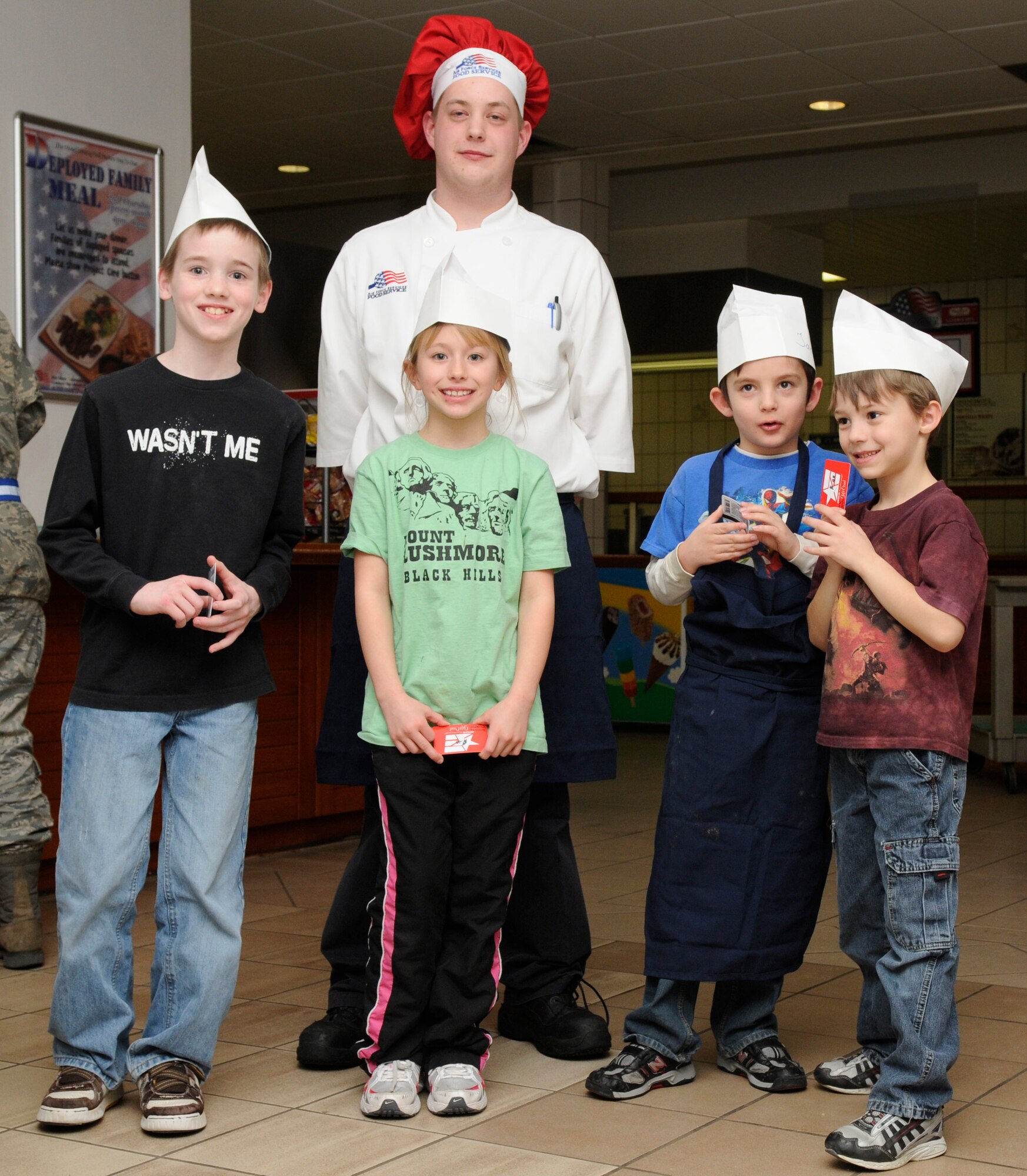 SPANGDAHLEM AIR BASE, Germany –Team Three takes first place in the Kid’s Iron Chef Competition with their sweet chicken curry dish at the Mosel Dining Facility Jan. 27. Team Three consisted of team leader Dennis Pautges, 52nd Force Support Squadron, (left to right) William Moreau, son of Tech. Sgt. Jay Moreau, 52nd Civil Engineer Squadron; Alex Harris, daughter of Master Sgt. Lance Harris, 52nd Logistics Readiness Squadron; Jacob Hite, son of Tamerra Hite, 52nd Contracting Squadron; and Noah Thomas, son of Capt. Wendy Hatter, 52nd Medical Operations Squadron.  (U.S. Air Force photo/Airman 1st Class Staci Miller)