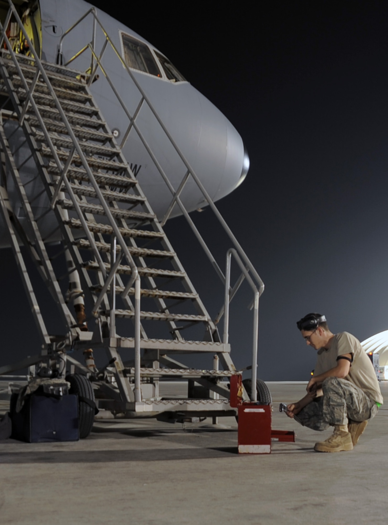 Senior Airman Clinton King, a KC-10 Extender maintenance Airman with the 380th Expeditionary Aircraft Maintenance Squadron, grabs tools from a tool box while working on a KC-10 on the flightline at a non-disclosed base in Southwest Asia on Jan. 31, 2010.  Airman King is deployed from the 605th Aircraft Maintenance Squadron at Joint Base McGuire-Dix-Lakehurst, N.J., and his hometown is Youngsville, N.C.  (U.S. Air Force Photo/Master Sgt. Scott T. Sturkol/Released)